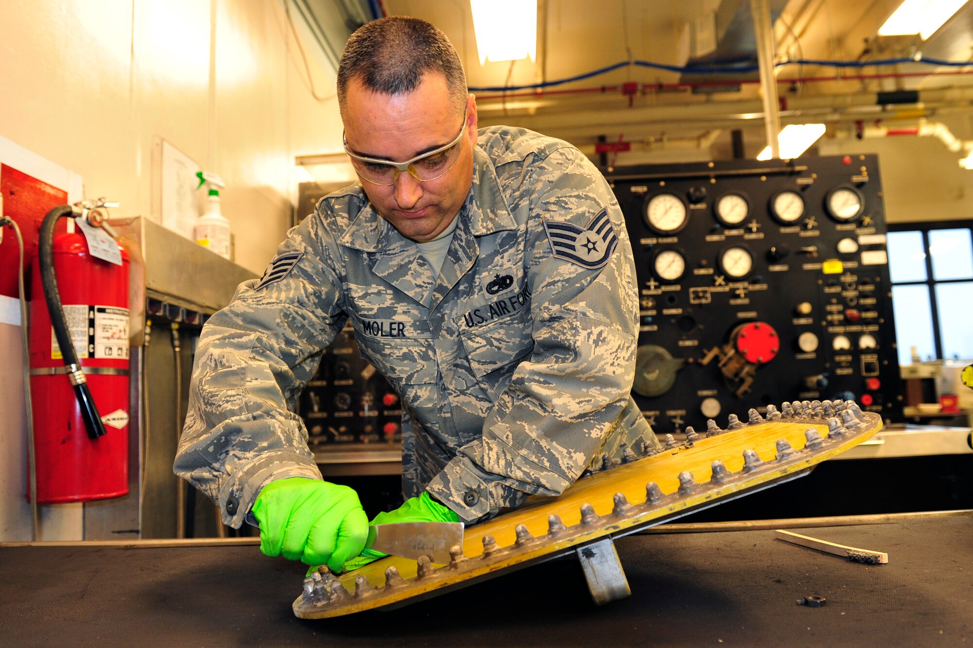 Staff Sgt. Brian Moler, 189th Maintenance Group aircraft fuel systems craftsman, removes defective sealant from a C-130 fuel tank access panel Dec. 8 to prevent further leaking. Sergeant Moler used forward thinking to co-author an H-II conversion aircraft fuel system training plan with six personnel qualified on 37 H-II fuel system tasks. He also meticulously managed a hazardous waste and materiel program and created a new hazardous waste disposal satellite accumulation point. (U.S. Air Force photo by Airman 1st Class Lausanne Pacheco)