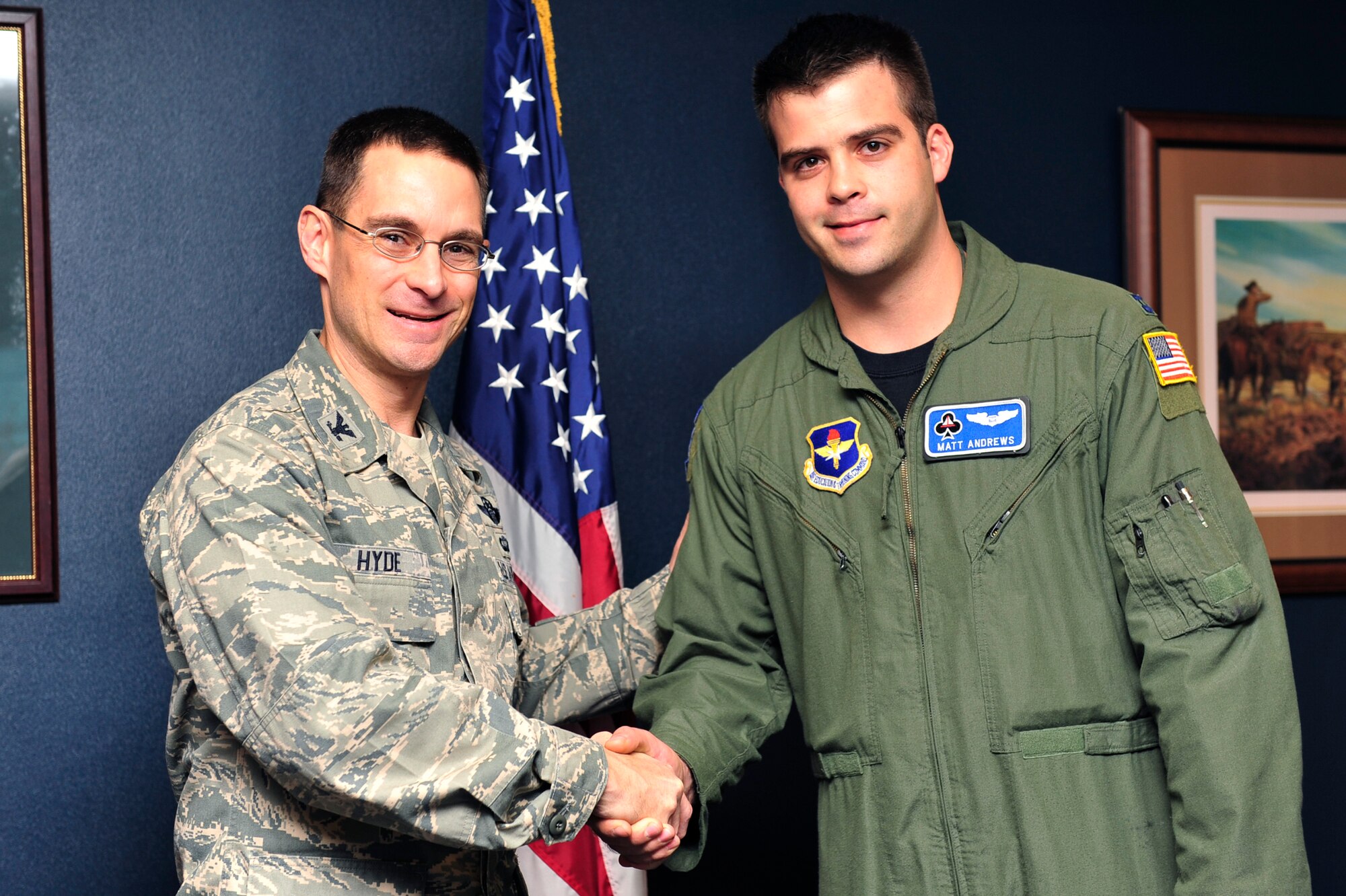Col. C. K. Hyde, 314th Airlift Wing commander, presents Capt. Matt Andrews, 62nd Airlift Squadron tactics officer, a 314th AW commander’s coin on base Dec. 2, for his accomplishments as the 314th AW Combined Federal Campaign representative. The 314th AW had 100 percent contact and 55 percent participation, totaling $52,170 in donations toward the 2010 CFC. (U.S. Air Force photo by Airman 1st Class Lausanne Pacheco)