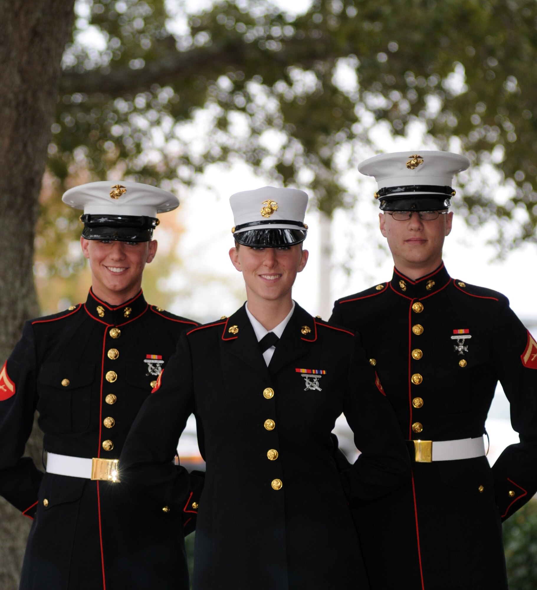 From left, Lance Cpls. Andrew and Elizabeth Foltz were at Keesler Dec. 2 for the graduation of their brother, Lance Cpl. Samuel Foltz, an aviation basic calibration pipeline student in Keesler’s Marine Corps Detachment.  The 19-year-old triplets hail from Michigan.  Andrew, a student at  West Michigan University, serves as a water purification specialist in the Marine Corps Reserves and plans to attend Officer Candidate School this summer.  Elizabeth is a motor transportation operator at Camp Lejeune, N.C.  Sam is headed to Cherry Point, N.C., where he’ll be calibrating aircraft tools.  Their parents, Denise Vaughan and Tom Foltz, and 4-year-old sister, Jacquelyn, came from Michigan for the graduation ceremony.  (U.S. Air Force photo by Kemberly Groue)