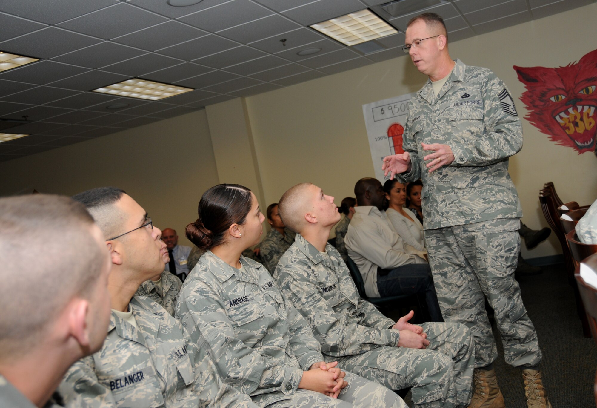 From left, Airman Basic Brenan Duffy, Airman Matthew Belanger and Airmen Basic Devin Andrade and Alex Anderson listen as Chief Master Sgt. Daniel Cummings, the Air Force’s cyberspace support career field manager, addresses the 13 graduates of the 336th Training Squadron’s first cyber surety apprentice course Dec. 2 at Thomson Hall.  (U.S. Air Force photo by Kemberly Groue)