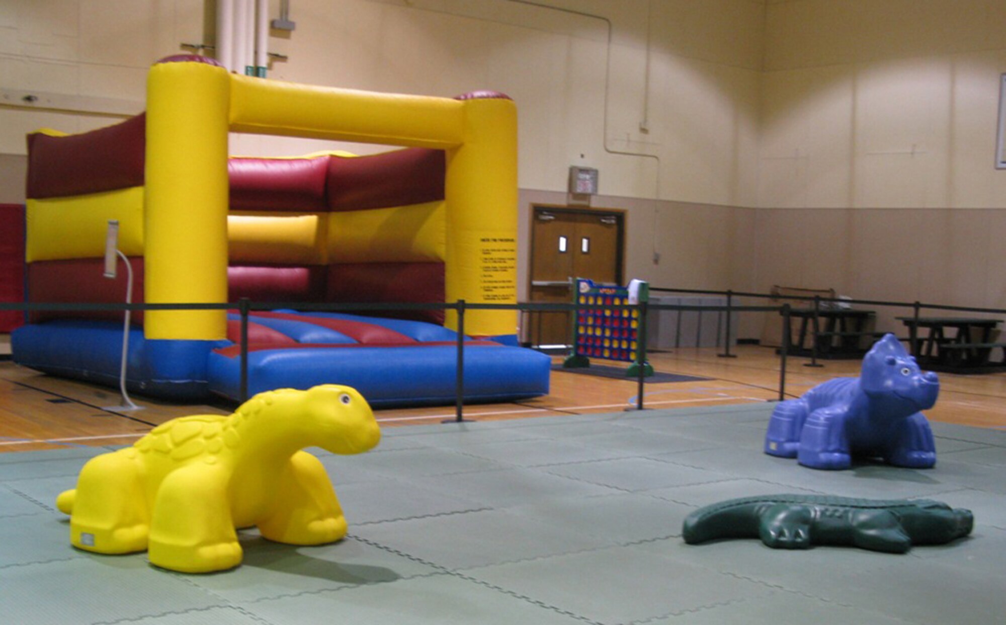 A bouncy castle to work off pent up energy for pre-schoolers, and a cushioned play area with soft toys to climb on for toddlers are featured in the new family fun zone. (U.S. Air Force courtesy photo)