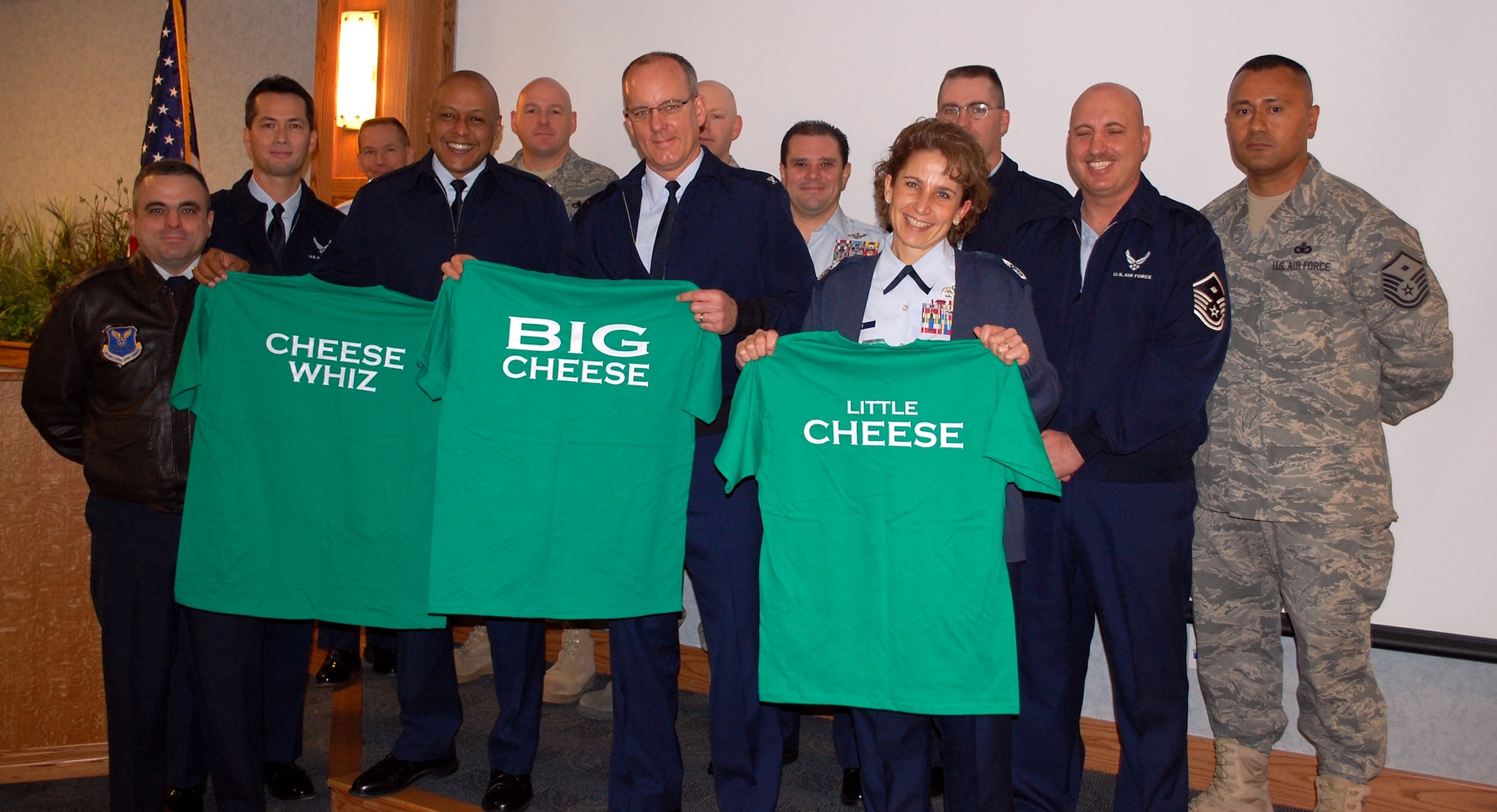 Maj. David Ashmore, 341st Force Support Squadron commander (far left) and members of the first sergeants council pose with leadership after presenting them with honorary Operation Holiday Cheer partipant shirts during Wing Standup Nov. 30. Pictured are Col. Anthony Cotton, 341st Missile Wing vice commander; Col. Michael Fortney, 341st Missile Wing commander; and Chief Master Sgt. Cari Kent, 341st Missile Wing command chief. (U.S. Air Force photo/2nd Lt. Marshel Slater)