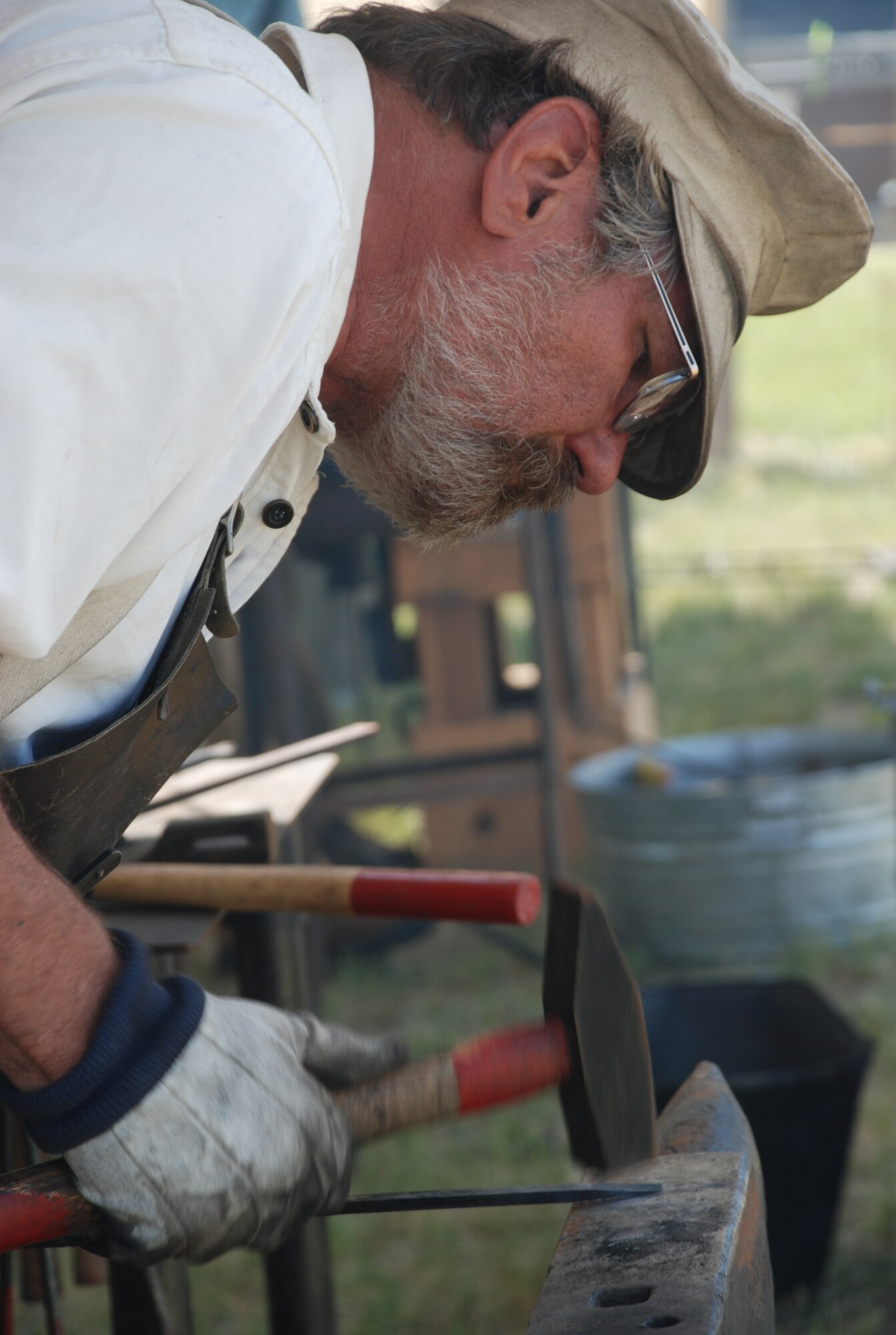 Jan Manning portrays a blacksmith during the living-history demonstrations at Fort D.A. Russell days July 11. Mr. Manning is making an S hook, which is used for hanging decorations and plants. A number of patrons were able to keep the S hooks as souveniers. (U.S. Air Force photo/Senior Airman Daryl Knee)