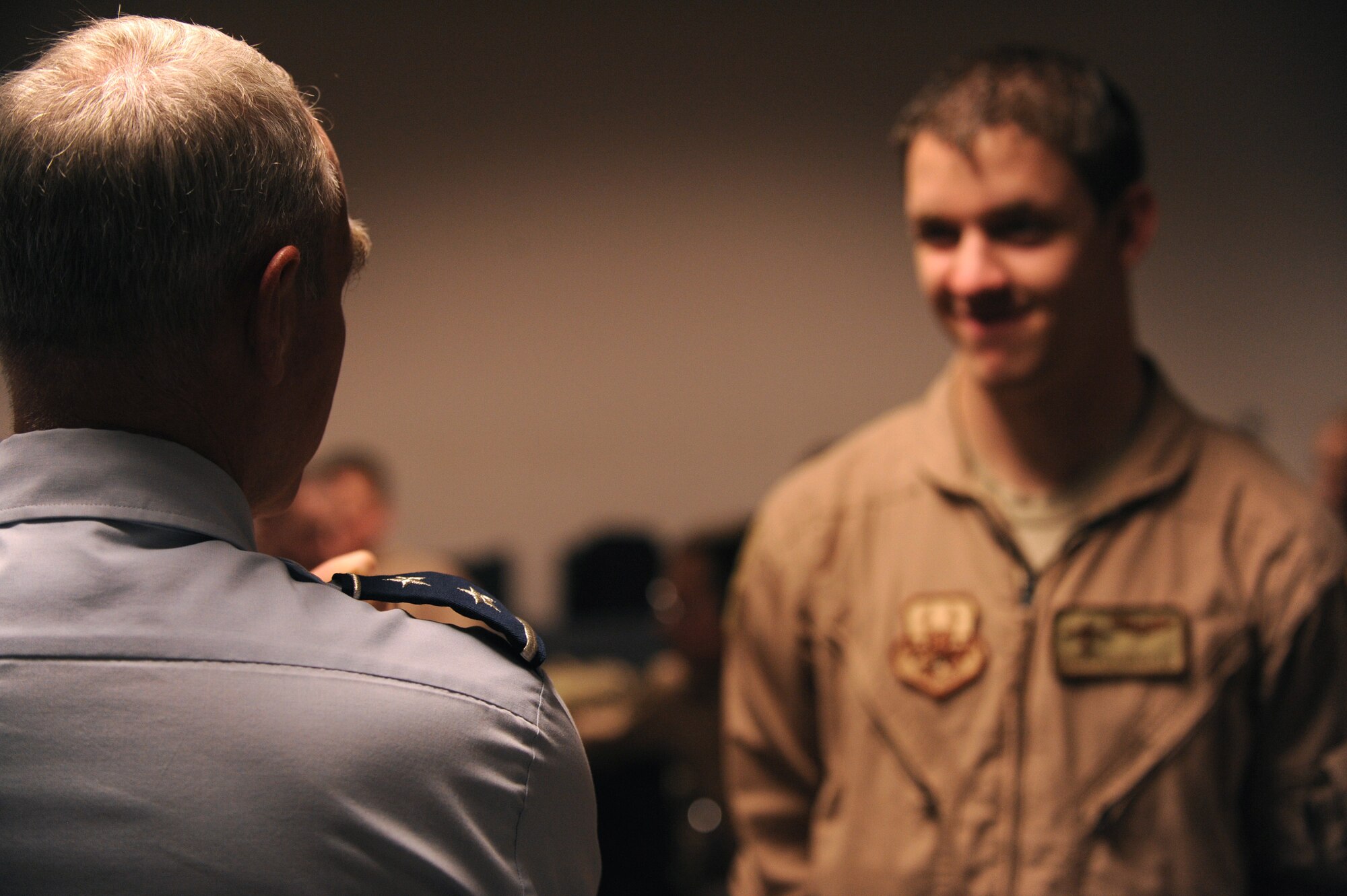MOODY AIR FORCE BASE, Ga. -- Maj. Gen. William Holland, commander of the 9th Air Force, Air Combat Command, Shaw Air Force Base, S.C., speaks with Airman 1st Class Brendyn Slapnicker, 71st Rescue Squadron airborne mission systems specialist, during a base visit here Dec. 7. Airman Slapnicker and other personnel from his unit were waiting to leave for a deployment. (U.S. Air Force photo by Airman 1st Class Benjamin Wiseman)