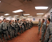 MINOT AIR FORCE BASE, N.D. -- Col. Douglas Cox, 5th Bomb Wing commander, addresses members of the 5th Security Forces Squadron before the start of their duty day here Dec. 4. Colonel Cox visited different work centers in an effort to meet the Airmen under his command in a more personal setting. His topics included the Air Force policy on alcohol and the wingman concept. (US Air Force photo by Staff Sgt. Keith Ballard)