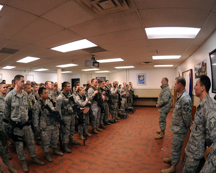 MINOT AIR FORCE BASE, N.D. -- Col. Douglas Cox, 5th Bomb Wing commander, addresses members of the 5th Security Forces Squadron before the start of their duty day here Dec. 4. Colonel Cox visited different work centers in an effort to meet the Airmen under his command in a more personal setting. His topics included the Air Force policy on alcohol and the wingman concept. (US Air Force photo by Staff Sgt. Keith Ballard)