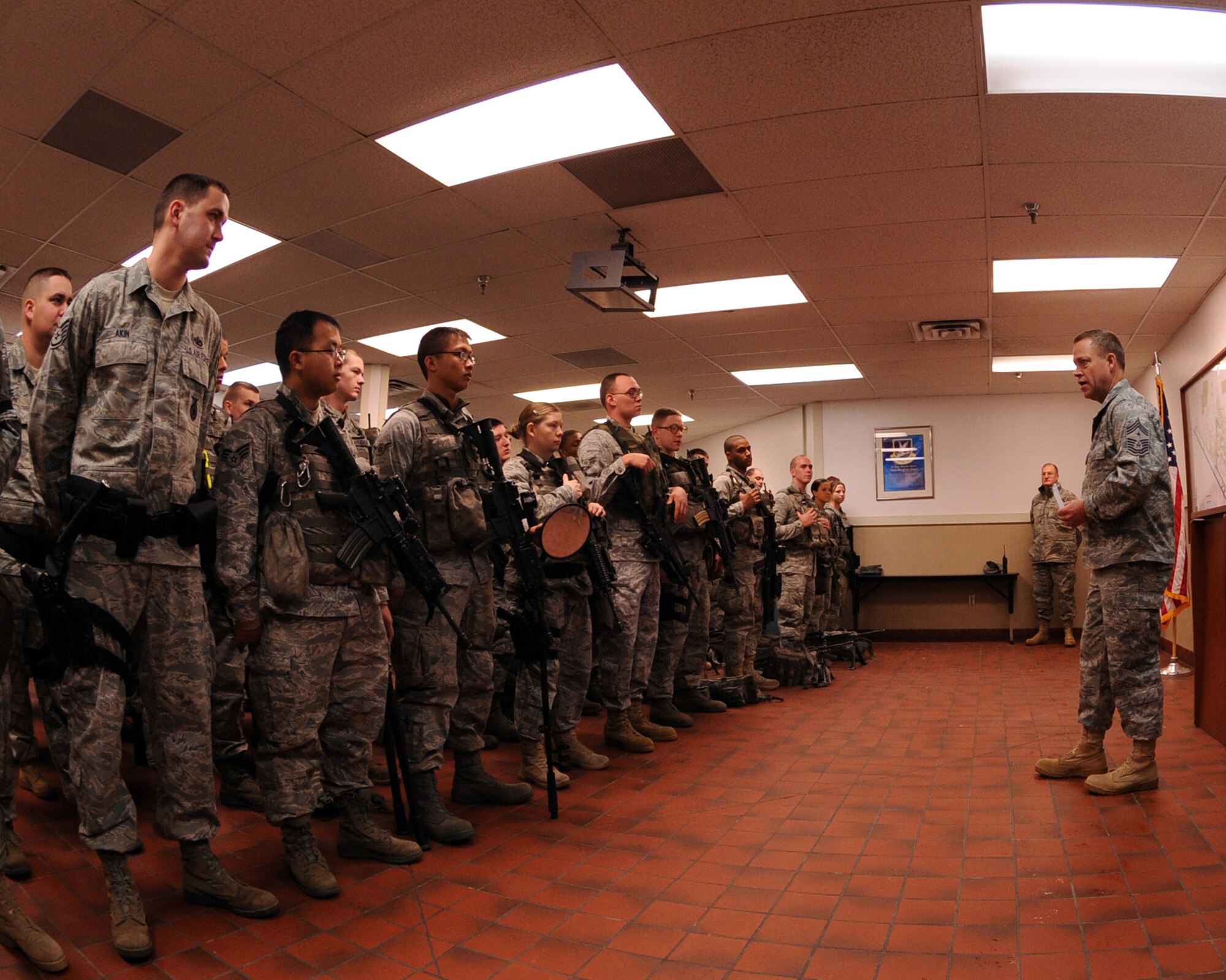MINOT AIR FORCE BASE, N.D. -- Chief Master Sgt. Martin Smith, 5th Bomb Wing command chief, addresses members of the 5th Security Forces Squadron before the start of their duty day here Dec. 4. Chief Smith visited different work centers in an effort to meet the airmen under his command in a more personal setting. His topics included the need for renewed family values and some specific subjects of the wingman concept. (US Air Force photo by Staff Sgt. Keith Ballard)