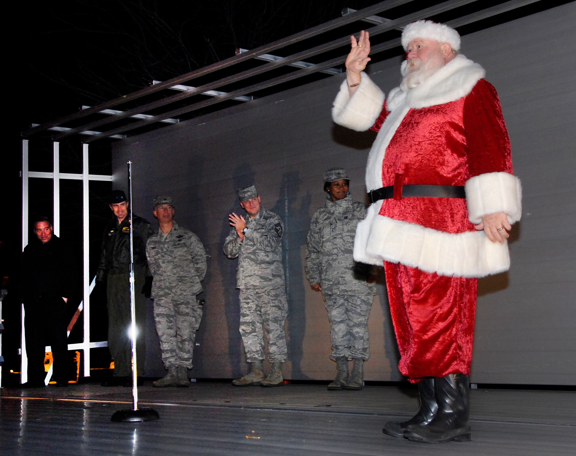 Santa speaks to the audience at the Annual Holiday Tree and Menorah Lighting Dec. 7 at the corner of Avenue E and 1st Avenue. (U.S. Air Force photo/Harry Tonemah)



