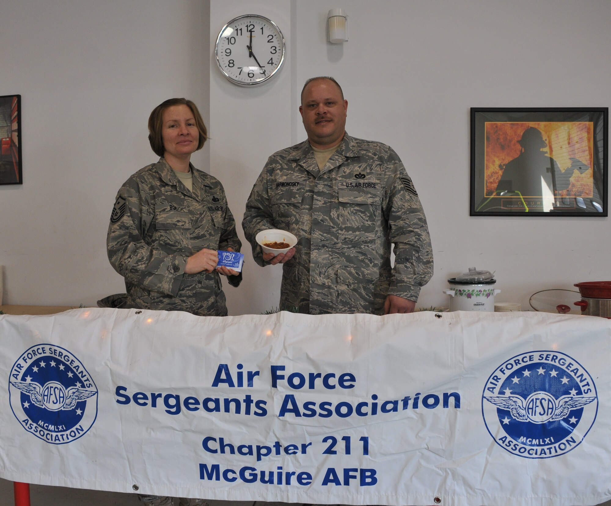 Master Sgt. Susan Roe, left, Air Force Sergeants Association president, presents a gift card to Tech. Sgt. Mark Harmonosky, 87th Civil Engineering Squadron, the winner of this year's Chili Cook-off contest. The contest was held at the Airmen's Firehouse, Dec. 8. Proceeds from the competition will be used to support the Airman Leadership School and the JROTC award programs in New Jersey, New York and Pennsylvania.
(U.S. Air Force Photo/Pascual Flores)