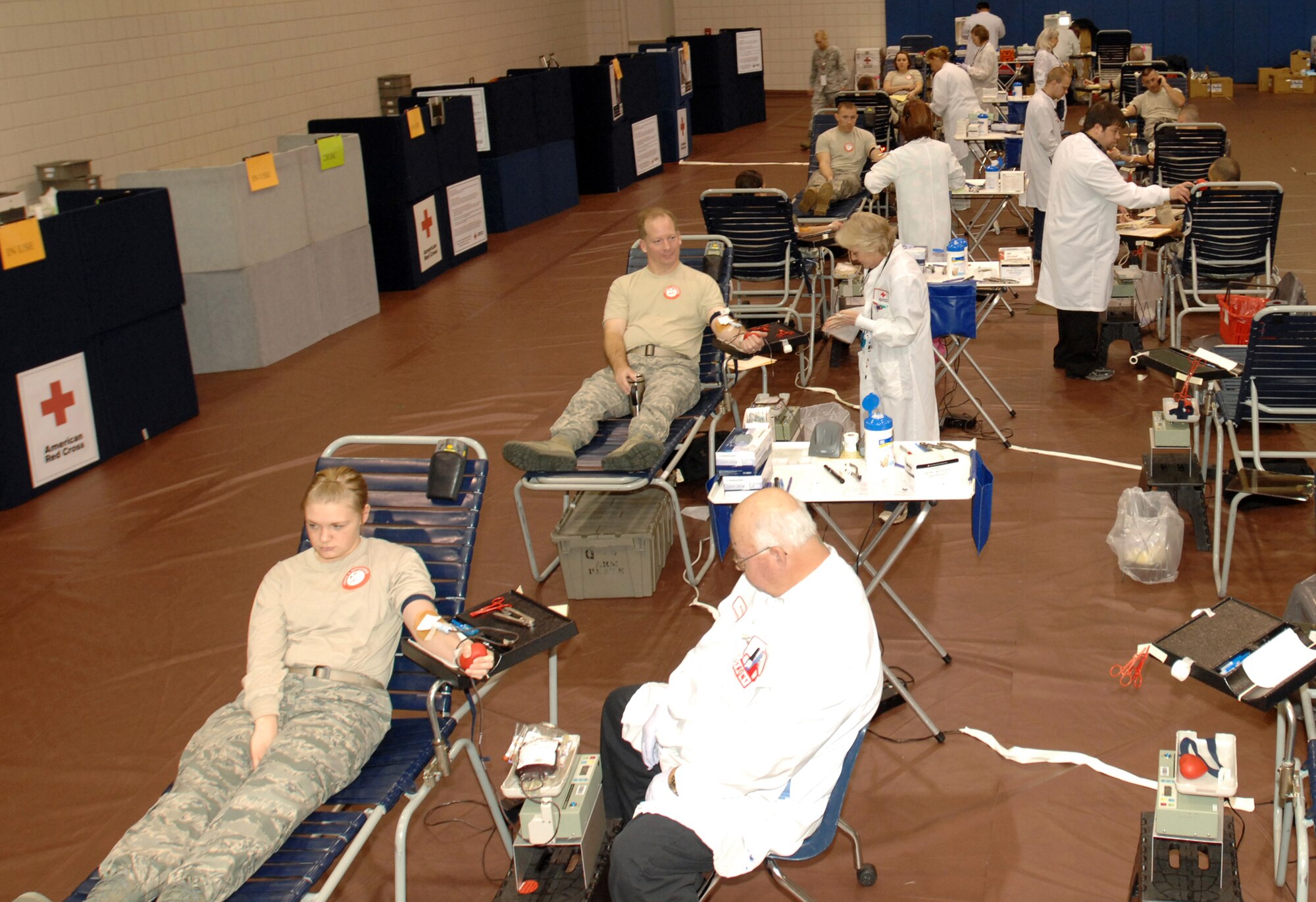 The American Red Cross members team up with Team McConnell to collect blood during a blood drive at McConnell Air Force Base, Kan., Dec. 4, 2009. Blood donors here provided 141 units of blood to the organization. (U.S. Air Force photo/Staff Sgt. Jamie Train) 