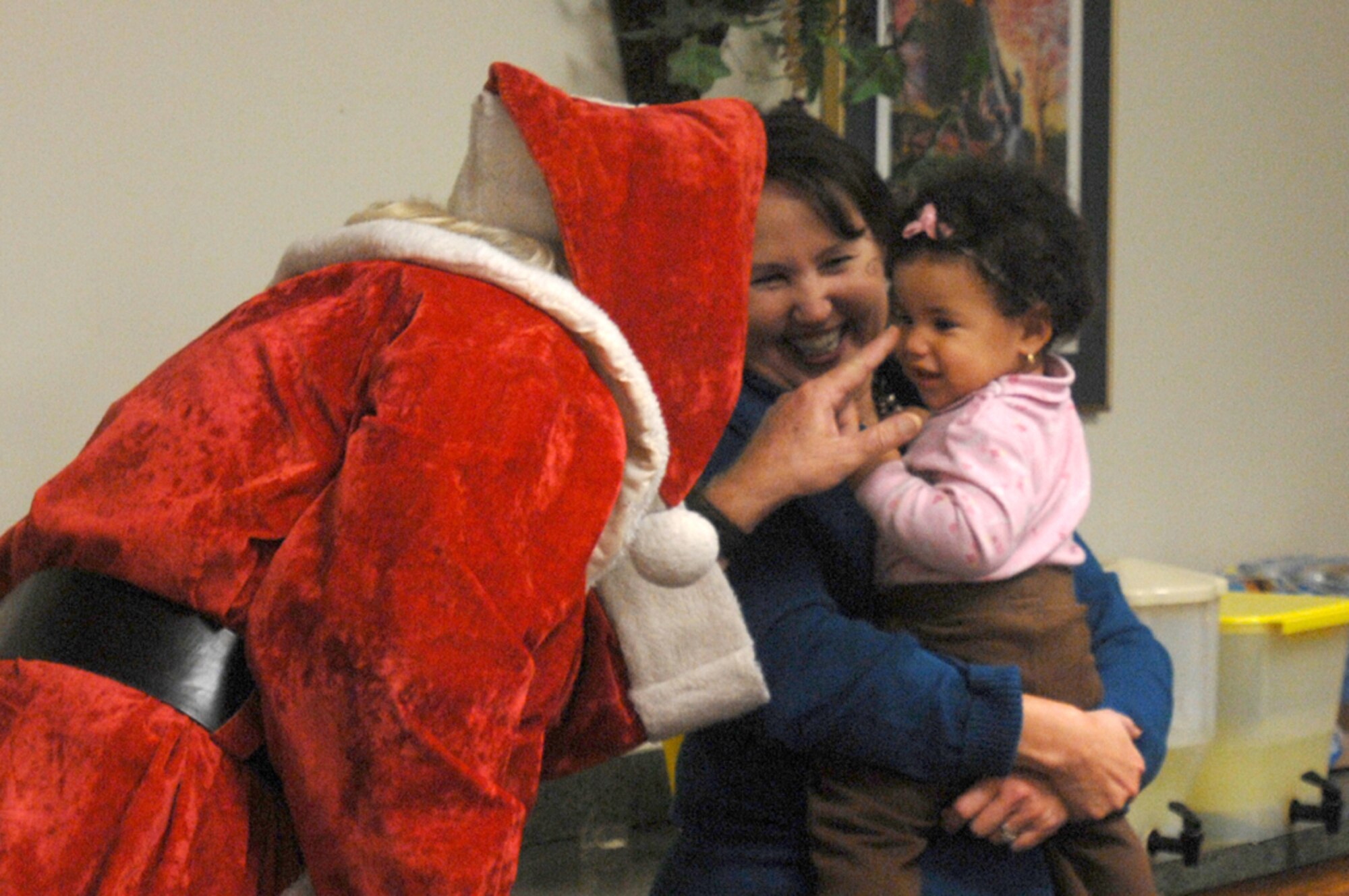 Santa Claus visits with a child during the Hearts Apart annual holiday party Dec. 4 at the Hurlburt Field Chapel. Throughout the year, the program sponsors a series of monthly gatherings for spouses and children of deployed members. (Air Force photo by Senior Airman Matthew Loken)
