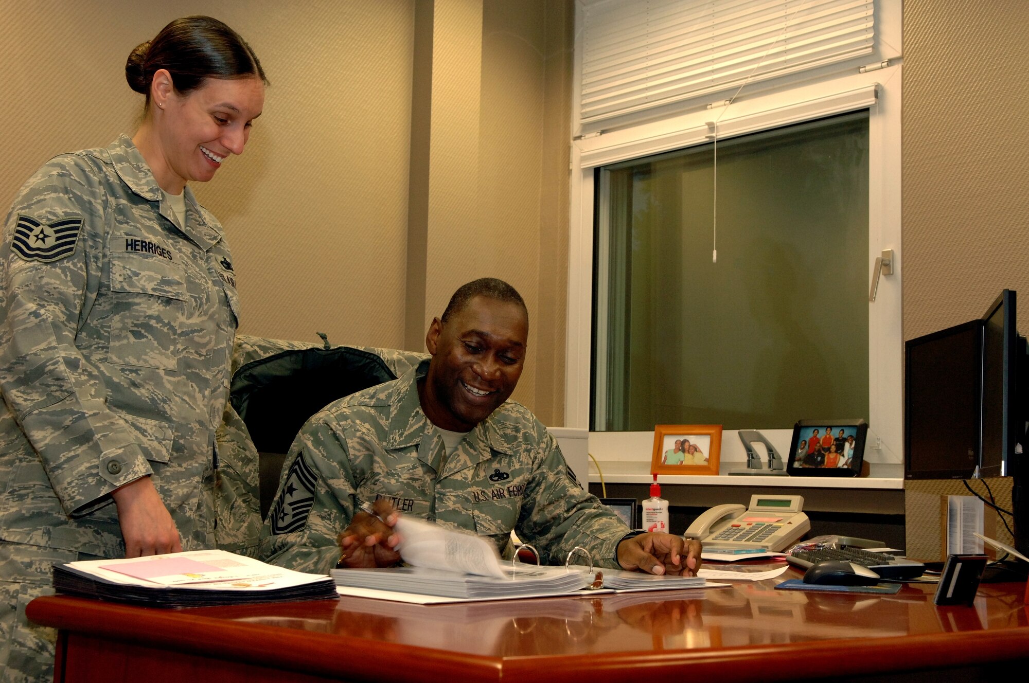 Tech. Sgt. Melanie Herriges, 86th Airlift Wing Executive Assistant
to the Command Chief, and Chief Master Sgt. Vernon Butler, 86th Airlift
Wing Command Chief, thumb through a continuity binder during the chief's
initial orientation period, Dec. 8, 2009. Chief Butler is the new 86th AW
Command Chief at Ramstein Air Base, Germany. (U.S. Air Force photo by Master Sgt.
Quinton T. Burris)
