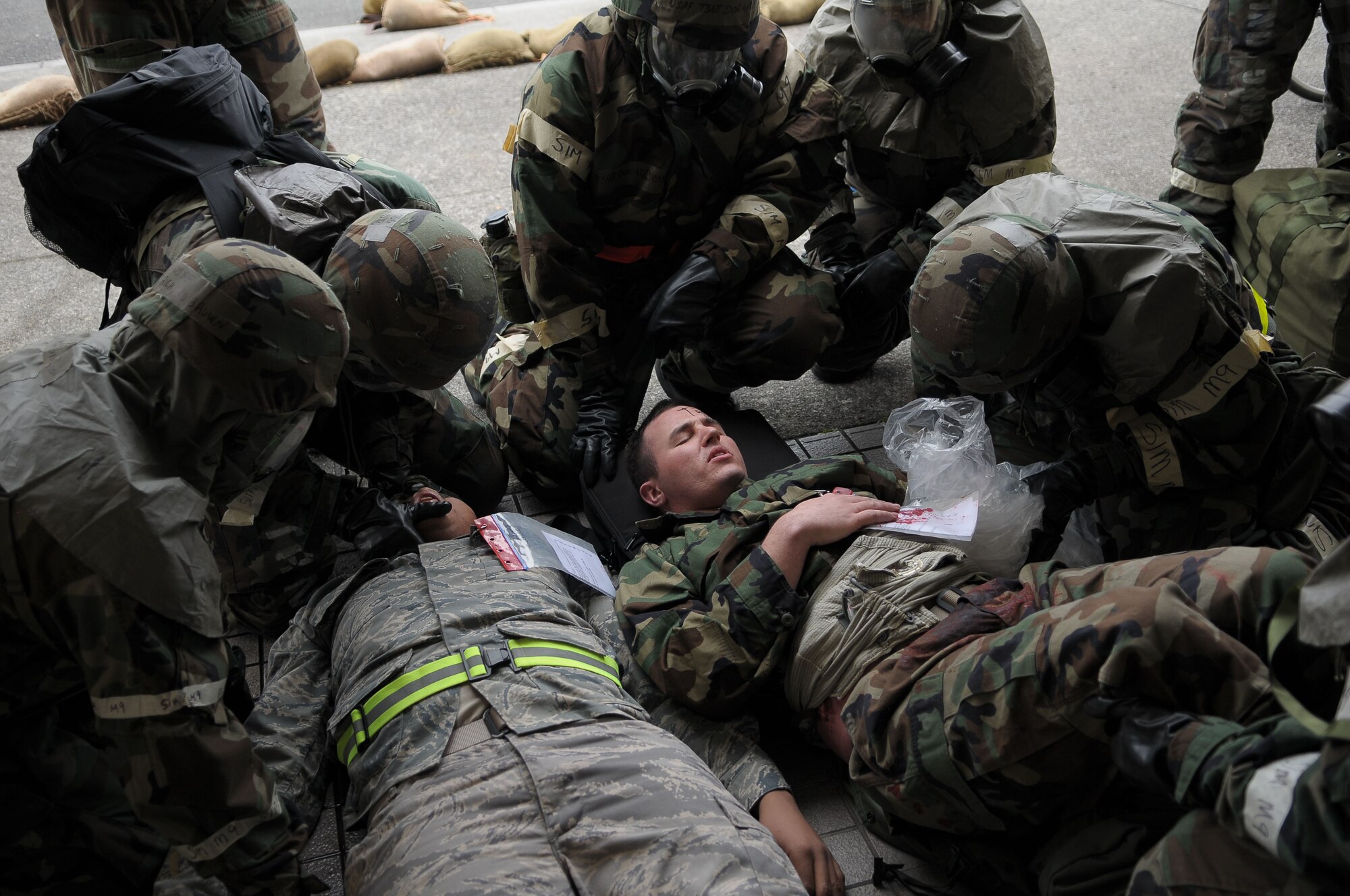 YOKOTA AIR BASE, Japan -- Airmen perform self aid and buddy care on casualties following a simulated attack Dec. 9 during an operational readiness inspection conducted by the Pacific Air Forces Inspector General. Basic lifesaving steps include: establish an open airway; ensure breathing; stop bleeding to ensure circulation; prevent further disability and minimize further exposure to adverse weather. (U.S. Air Force photo/Airman 1st Class Sean Martin)
