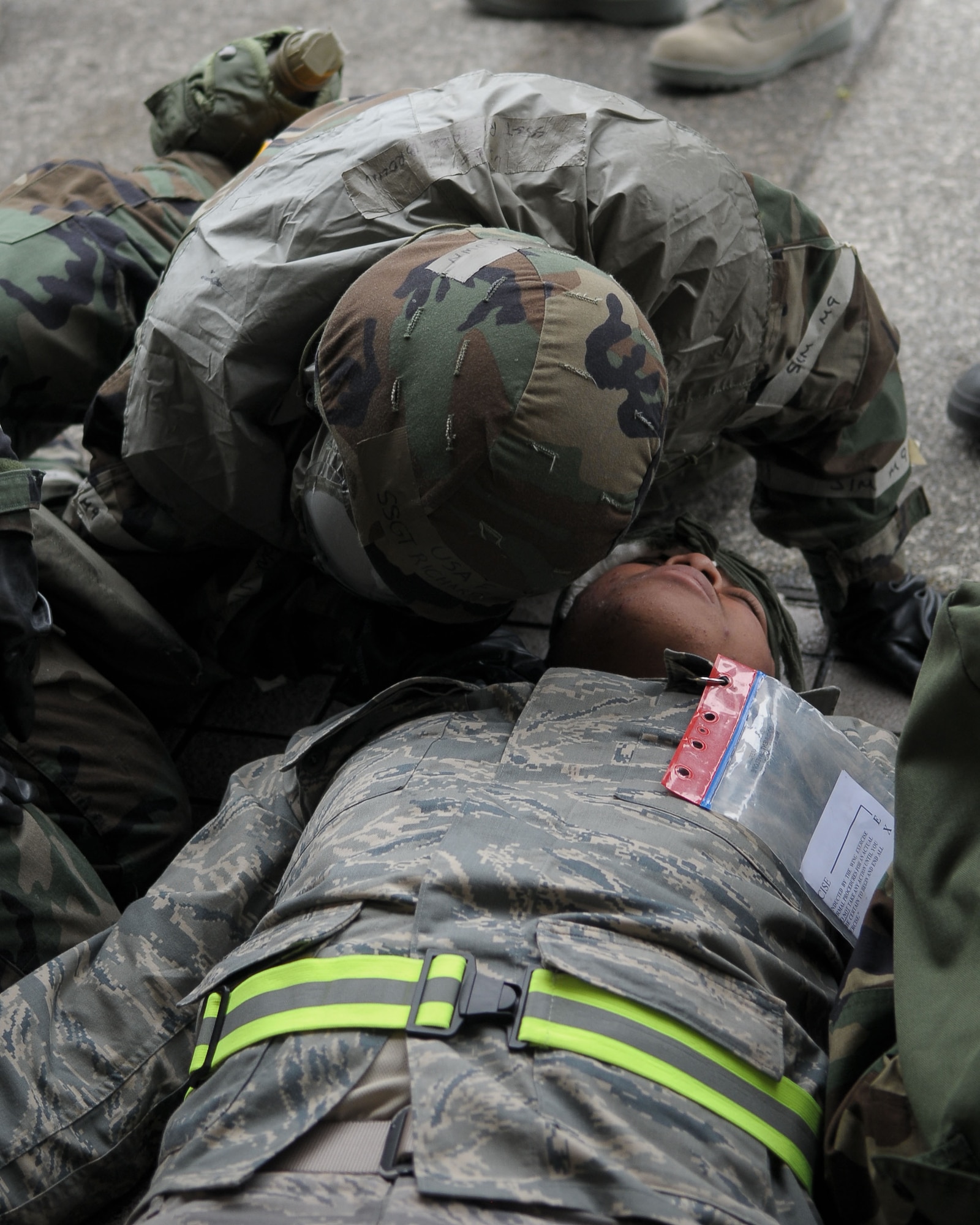 YOKOTA AIR BASE, Japan -- An Airman checks to see if a victim is breathing following a simulated attack Dec. 9 during on operational readiness inspection conducted by the Pacific Air Forces Inspector General. Basic lifesaving steps include: establish an open airway; ensure breathing; stop bleeding to ensure circulation; prevent further disability and minimize further exposure to adverse weather. (U.S. Air Force photo/Airman 1st Class Sean Martin)