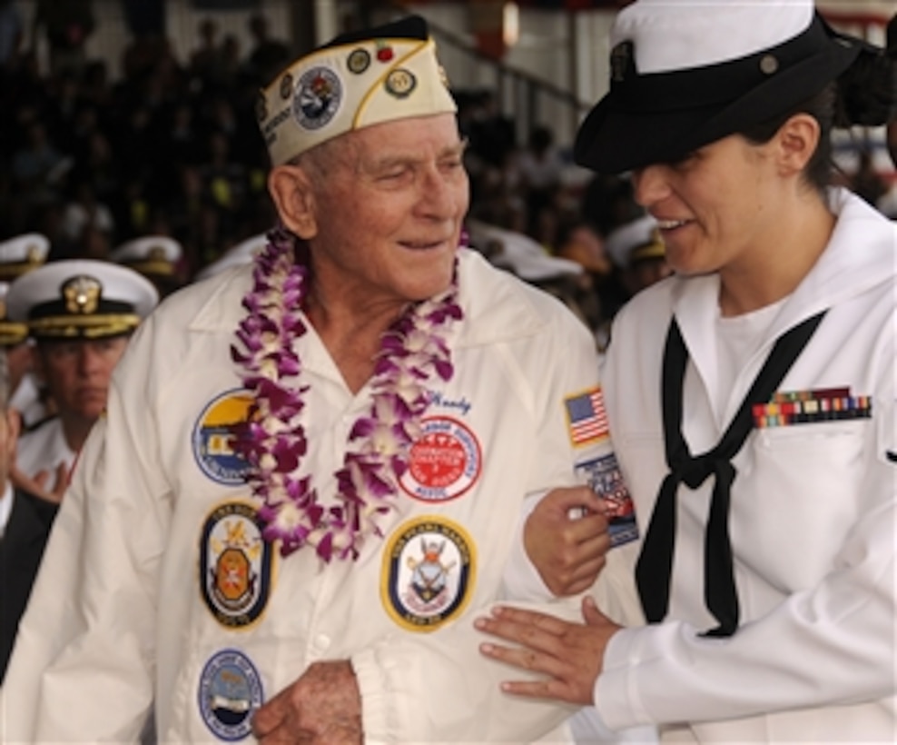 Woody Derby, a Pearl Harbor survivor, escorted by U.S. Navy Petty Officer 3rd Class Kathleen McDowell honors the USS Nevada (BB 36) as they celebrate Pearl Harbor Day at Pearl Harbor, Hawaii, on Dec. 7, 2009.  The National Park Service and the U.S. Navy are hosting a joint memorial ceremony with more than 2,000 distinguished guests, the general public and military personnel, both active and retired, to commemorate the 68th anniversary of the attack on Pearl Harbor.  The theme of the ceremony was "But Not in Shame: The Aftermath of Pearl Harbor."  