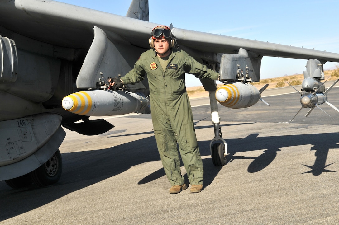 Cpl. Michael Wilkinson, ordnance technician with Marine Attack Squadron 211, ensures Mark 82 bombs are properly secured on one of the squadron’s AV-8B Harriers at the Yuma Proving Ground Dec. 9, 2009. The squadron prepared for future deployments by using the airfield to simulate a forward operating base’s airstrip, to reloads live ordnance on the aircraft while it is still running. “It was a good exercise to bring the ordnance shop in as a team, rather than individuals,” said Wilkinson. The squadron is based at the Marine Corps Air Station in Yuma, Ariz.
