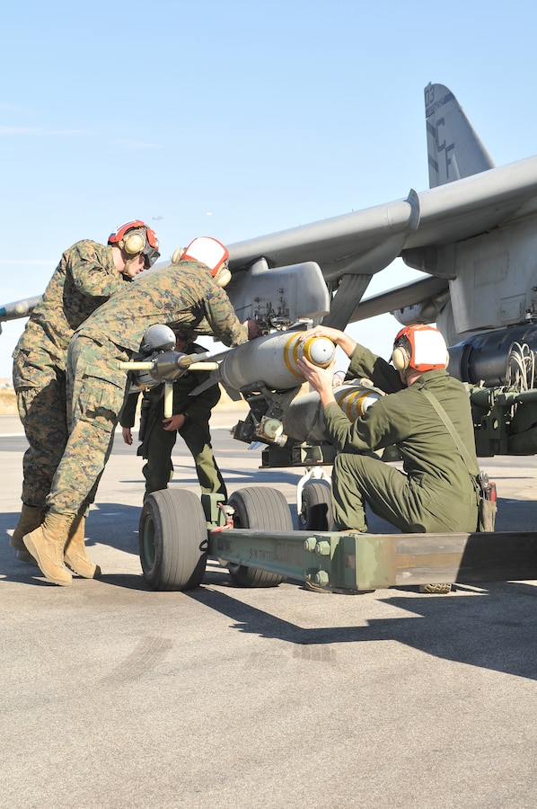Ordnance technicians with Marine Attack Squadron 211 reload an AV-8B Harrier with Mark 82 bombs as part of a hot reloading exercise at the Yuma Proving Ground Dec. 9, 2009. Hot reloading requires personnel to secure live ordnance onto the aircraft while the aircraft is still running. The reloading was part of Exercise Prairie Fire, which had the Marines working as if they were on the airstrip of a forward operating base. “The purpose of these types of exercises is to prepare Marines for their next deployment,” said Capt. Timothy Hudson, squadron pilot. The squadron is based at the Marine Corps Air Station in Yuma, Ariz.