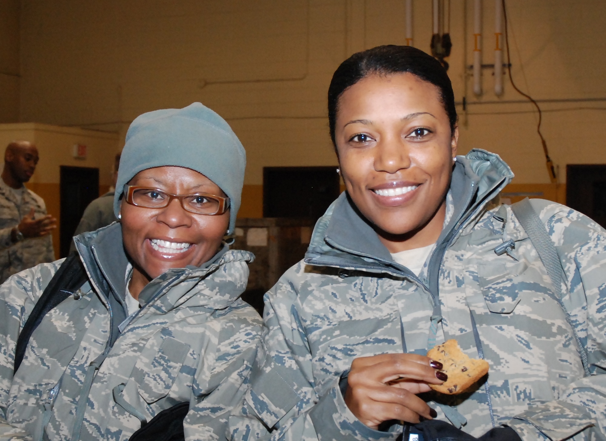 Tech. Sgts. Patricia Jeter (left) and Sharon Solomon, 94th Aeromedical Staging Squadron medical technicians, share a smile and refreshments provided by Dobbins ARB Services after redeploying from an Operational Readiness Inspection Dec. 10.  “I needed this experience in preparation for my next deployment to Southwest Asia,” said Sergeant Jeter.  “All of our participants had good attitudes and a good sense of urgency.”  (U.S. Air Force photo/Master Sgt. Stan Coleman)
