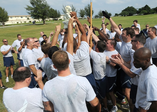 KADENA AIR BASE, Japan -- Members of the 320th Special Tactics Squadron hoist the championship trophy over their heads and cheer after winning the inagural 353rd Special Operations Group Sports Week Nov. 30 - Dec. 4.  Sports week pitted the units assigned to the group against each other in 10 sporting events ranging from basketball to a modified relay race. (U.S. Air Force photo by Tech. Sgt. Aaron Cram)