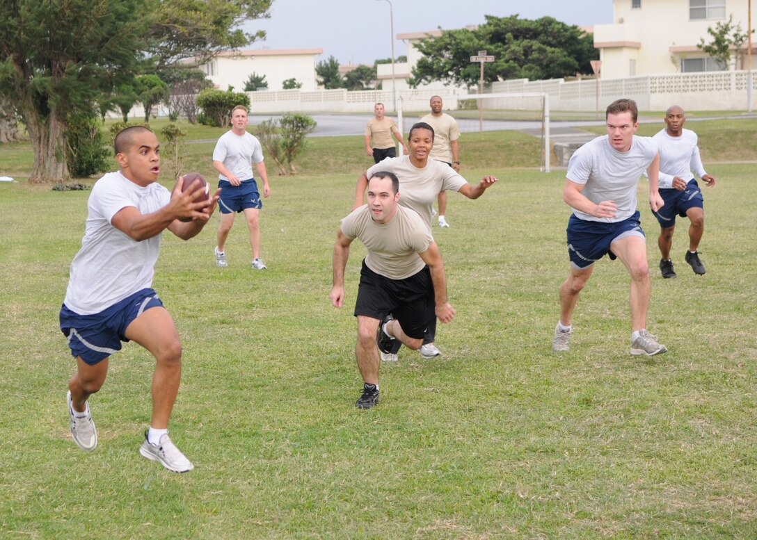 KADENA AIR BASE, Japan -- Jed Bilibei, from the 17th Special Operations Squadron team, catches a pass against the 320th Special Tactics Squadron during the ultimate football championship game Dec. 3 which was part of the inaugural 353rd Special Operations Group Sports Week Nov. 30 - Dec. 4.  Sports week pitted the units assigned to the group against each other in 10 sporting events ranging from basketball to a modified relay race. The 17th SOS won the ultimate football championship during sports week. (U.S. Air Force photo by Tech. Sgt. Aaron Cram)