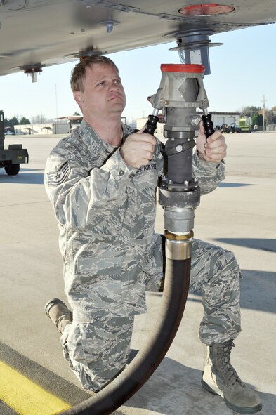 Tech. Sgt. Jayson Kennedy, a fuels technician, prepares to attach the single point line to the B-52 Stratofortress at Barksdale Air Force Base, La., flightline Dec. 4, 2009. Sergeant Kennedy is assigned to the 917th Wing at Barksdale. (U.S. Air Force photo/Senior Airman Crystal Jordan)