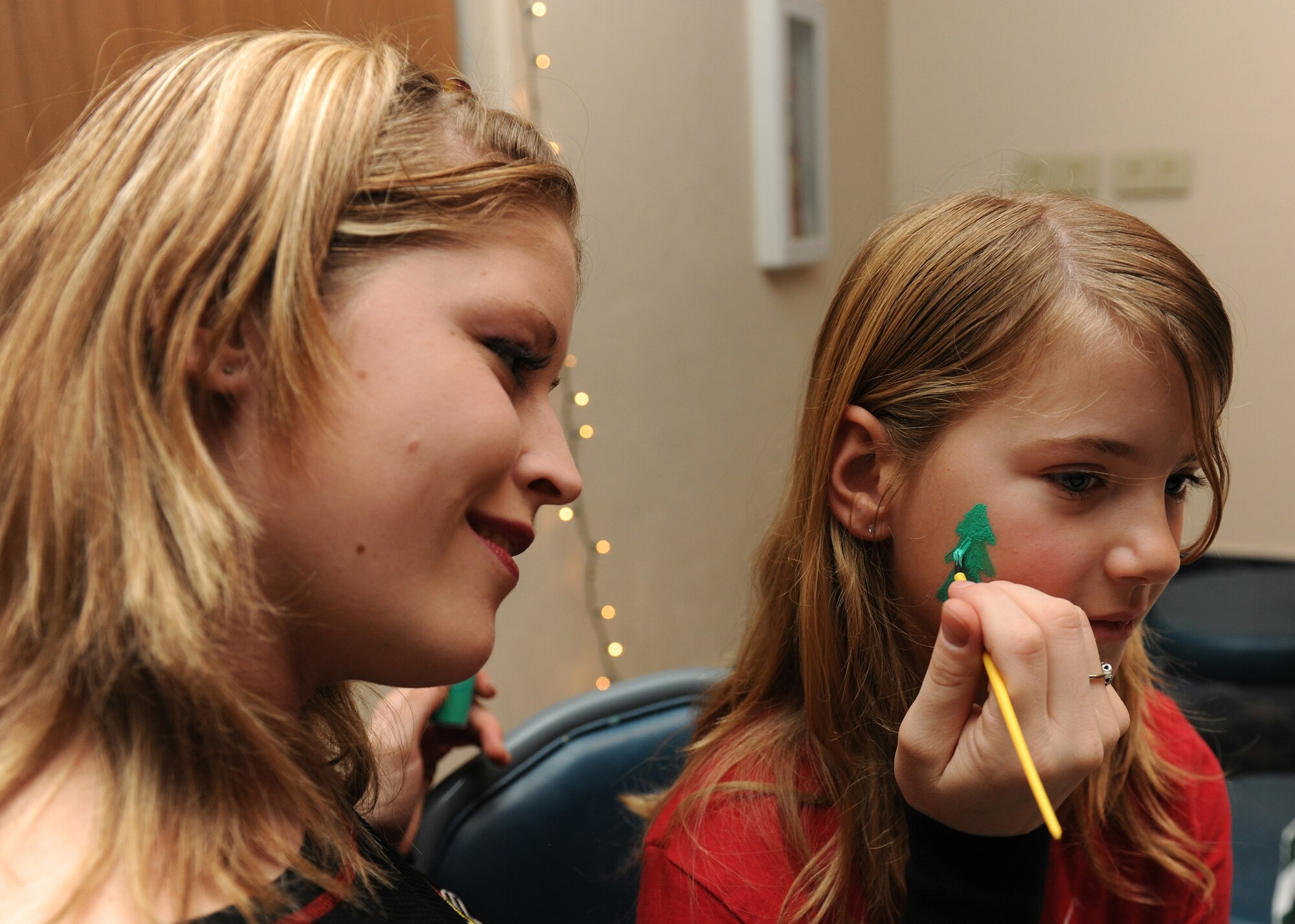 HOLLOMAN AIR FORCE BASE, N.M. -- Airman 1st Class Melissa Smith, 49th Medical Group, volunteers to paint faces for children attending the Families Apart Dinner at the Desert Sands Enlisted Club, Dec. 9. The Airman and Family Readiness Center holds a Families Apart Dinner at least every quarter for spouses and children of deployed members to get together and enjoy a dinner and crafts. The 49th Force Support Squadron hosted the Families Support Dinner in conjunction with the Deployment Expo. (U.S. Air Force photo by Senior Airman Michael Means)