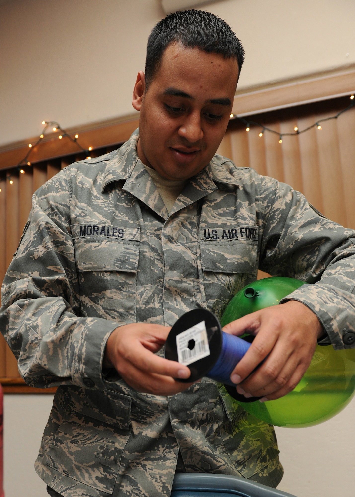 HOLLOMAN AIR FORCE BASE, N.M. -- Senior Airman Pedro Morales, 44th Fighter Group, volunteers to blows up balloons for children attending the Families Apart Dinner at the Desert Sands Enlisted Club, Dec. 9. The Airman and Family Readiness Center holds a Families Apart Dinner at least every quarter for spouses and children of deployed members to get together and enjoy a dinner and crafts. The 49th Force Support Squadron hosted the Families Support Dinner in conjunction with the Deployment Expo. (U.S. Air Force photo by Senior Airman Michael Means)