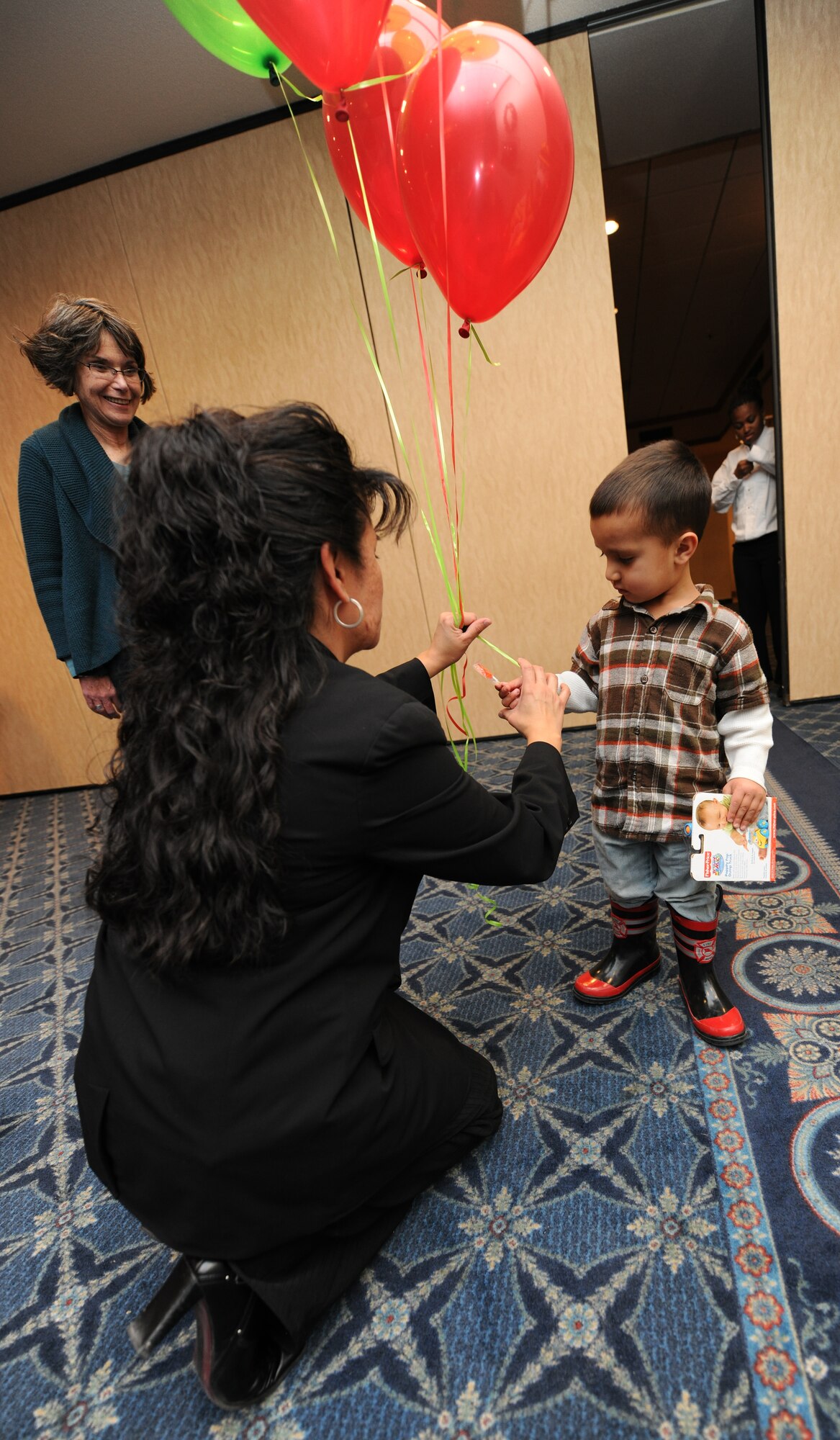 HOLLOMAN AIR FORCE BASE, N.M. -- Members of Team Holloman attend the Families Apart Dinner at the Desert Sands Enlisted Club, Dec. 9. The event was for families of military personnel deployed, remote or on extended temporary duty. The event had givaways, face painting, crafts for children, balloons and a free dinner. The Airman and Family Readiness Center holds a Families Apart Dinner at least every quarter for spouses and children of deployed members to get together and enjoy a dinner and crafts.  (U.S. Air Force photo by Senior Airman Michael Means)