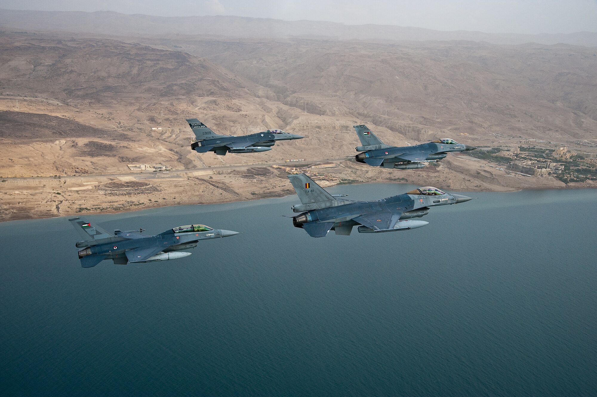 A diamond formation of F-16 Fighting Falcons flies over the Dead Sea, looking back on the coast of Jordan, during a formation flight with the three countries who were participating in the 2009 Falcon Air Meet, Belgium, United States, and Jordan. The Falcon Air Meet is an annual competition for countries around the world that fly F-16 Fighting Falcons.(Official U.S. Air Force photo by Capt. Darin Overstreet, Colorado National Guard/Released)