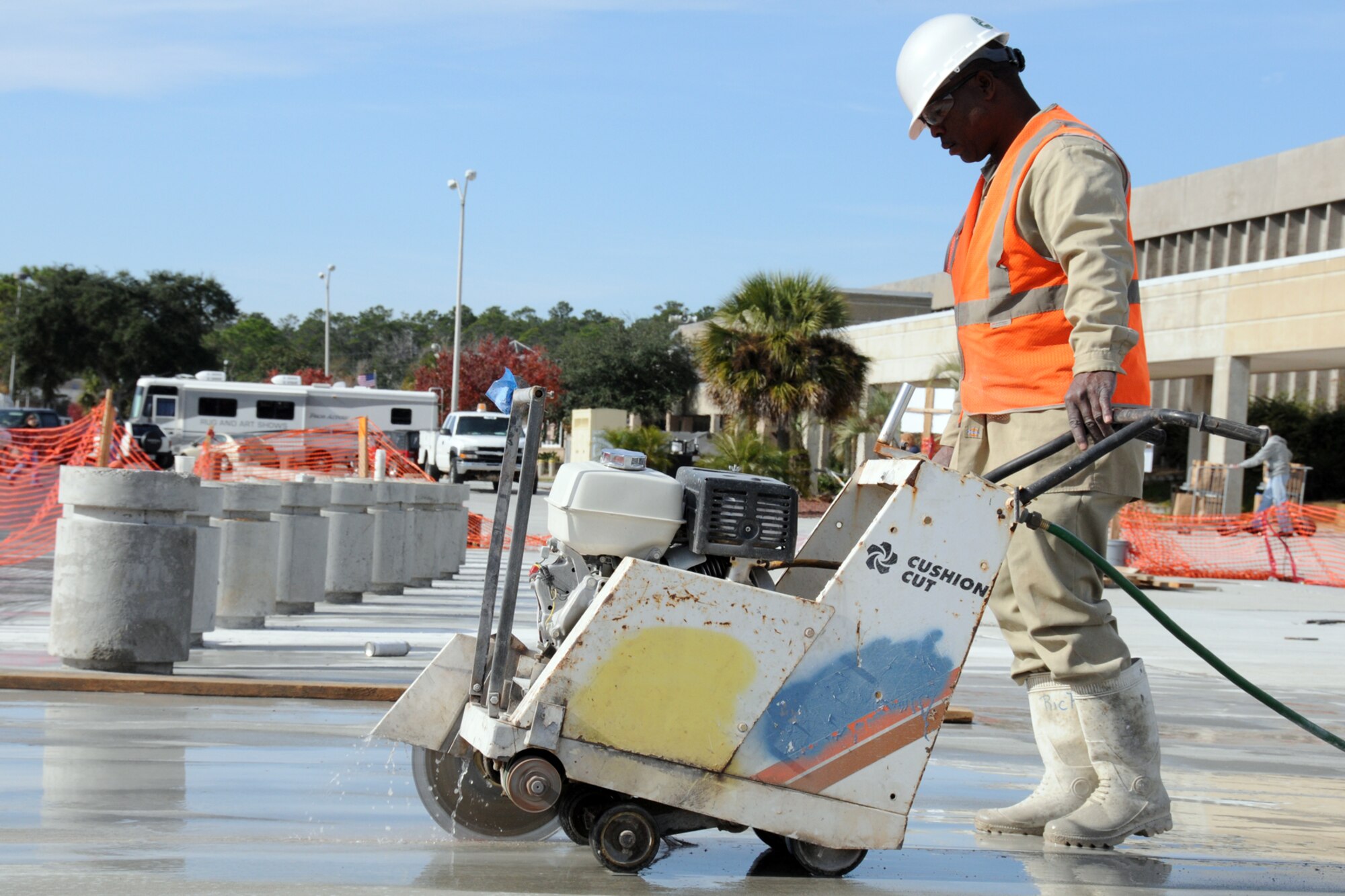 EGLIN AIR FORCE BASE, Fla. – Kirk Rich cuts control relief joints in the pavement in front of the Commissary here, Dec. 10. Expansion of the sidewalk in front of the building is part of an initiative to meet Homeland Security policy for federal buildings. Barriers have been put in place to prevent the threat of a vehicular bombing attempt. Though the expansion increases the distance from the parking lot to the front door, it decreases the impact a possible terrorist attack may have on the building and customers. The project is scheduled for completion by fall of 2010. (U.S. Air Force photo/ Airman 1st Class Anthony Jennings)