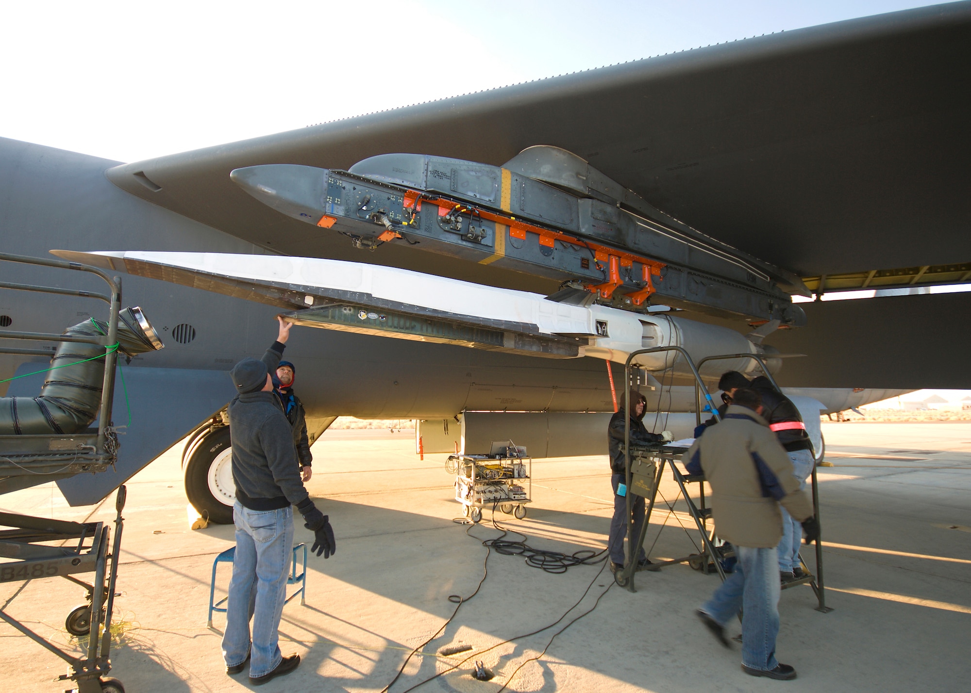 Crew members prepare the X-51A for a captive carry flight under the B-52 Stratofortress Dec. 9. The captive carry is part of the preparations being made prior to the first flight. (U.S. Air Force photo/Mike Cassidy)