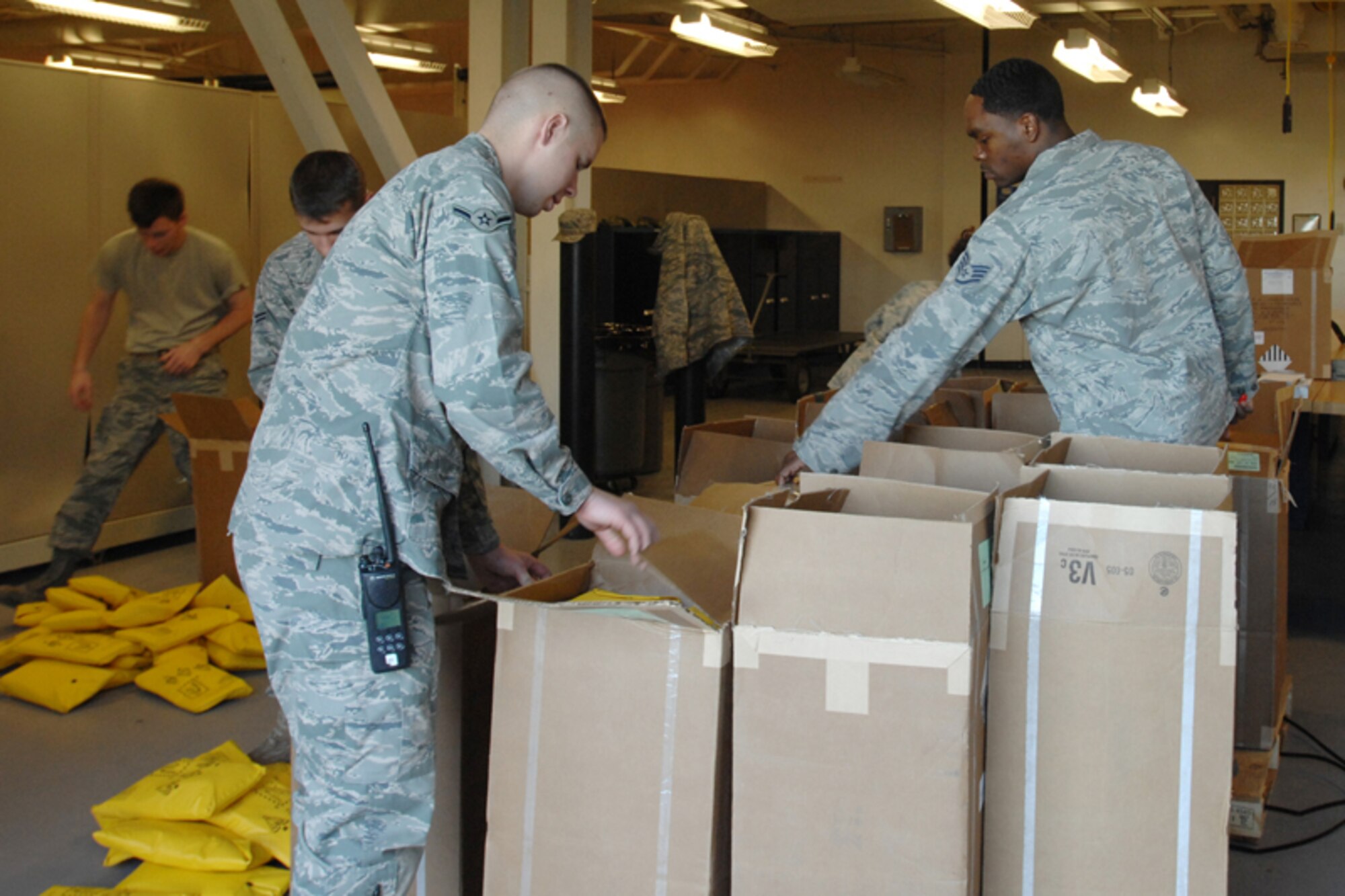 Airman Jesse Moore, left, 22nd Logistics Readiness Squadron vehicle operator, helps Airmen from the 22nd Operation Support Squadron life support section account for more than 500 life preservers, Dec. 1, 2009. (U.S. Air Force photo/Staff Sgt. Jamie Train)