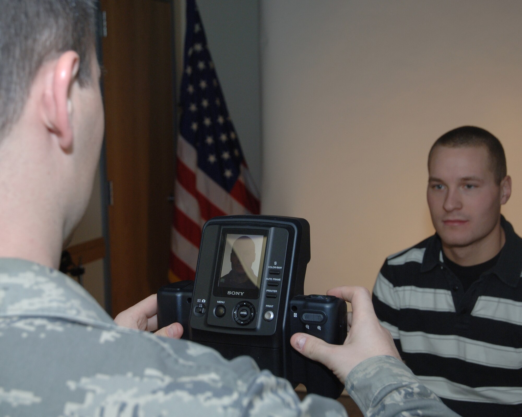 Staff Sgt. Jared R. Frey, 319th Air Refueling Wing Public Affairs, takes a passport photo Dec. 10 in the Grand Forks Air Force Base photo studio. The 319th ARW Public Affairs recently set new hours of operation for the photo studio. All official and passport photos will be taken Mondays and Wednesdays from noon to 3 p.m. and Tuesdays and Thursdays from 8 a.m. to noon by appointment only. For more information or to make an appointment, call (701) 747-5023. (U.S. Air Force photo by Senior Airman R. Michael Longoria)