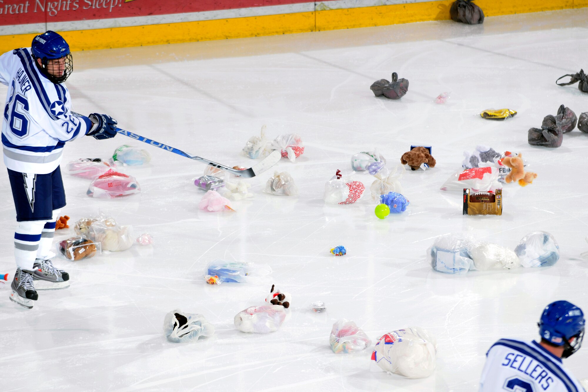 Falcons forward Jeff Hajner and defender Brad Sellers rein in toys from the "Toy Trick" after the Falcons scored their first goal of the game against American International College Dec. 5, 2009, at the Air Force Academy's Cadet Ice Arena. The Falcons have distributed more than 5,000 toys to children in local hospitals and clinics during the Toy Trick's 10 years of operations. Hajner, a senior, is from Las Vegas. Sellers, a junior, is from Centenniel, Colo. (U.S. Air Force photo/J. Rachel Spencer)