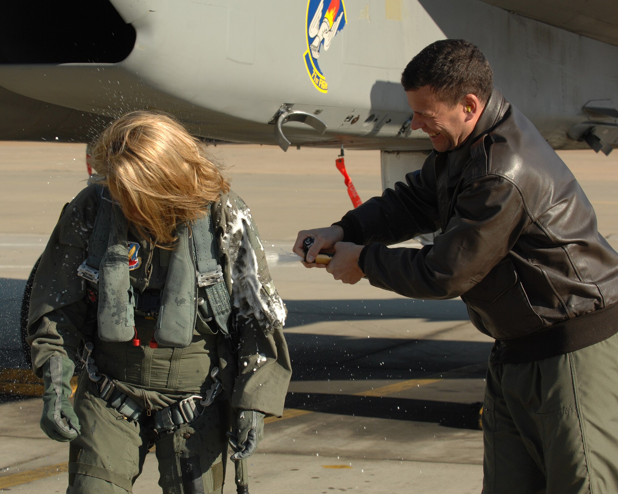 LANGLEY AIR FORCE BASE, Va. -- Col.Matt Molloy, 1st Fighter Wing commander, sprays champagne on Molly Ward, Hampton mayor, after her orientation flight Dec. 10. The 1st Fighter Wing granted Mayor Ward the orientation flight to familiarize her with the the Langley mission.(U.S. Air Force photo/Senior Airman Scott Aldridge)
