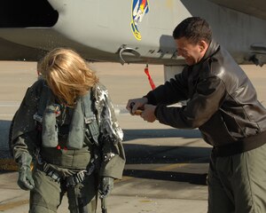 LANGLEY AIR FORCE BASE, Va. -- Col.Matt Molloy, 1st Fighter Wing commander, sprays champagne on Molly Ward, Hampton mayor, after her orientation flight Dec. 10. The 1st Fighter Wing granted Mayor Ward the orientation flight to familiarize her with the the Langley mission.(U.S. Air Force photo/Senior Airman Scott Aldridge)
