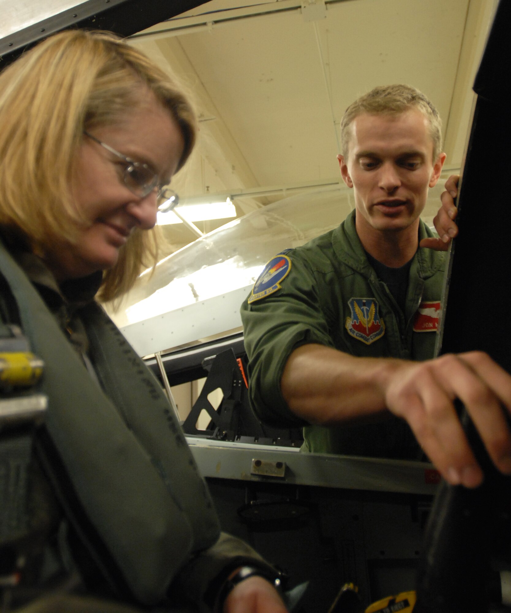 LANGLEY AIR FORCE BASE, Va. -- Capt. Jon Hassell, 71st Fighter Squadron standard evaluation chief, goes over cockpit controls with Molly Ward, Hampton mayor, prior to her orientation flight Dec. 10. The 1st Fighter Wing granted Mayor Ward the orientation flight to familiarize her with the the Langley mission.(U.S. Air Force photo/Senior Airman Scott Aldridge)