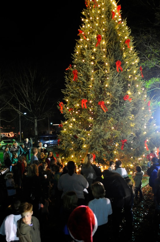 LANGLEY AIR FORCE BASE, Va. — Team Langley family members gather around the tree following the annual tree-lighting ceremony Dec. 9 at the Bethel Manor Chapel.  The tree was purchased by Team Langley members from Maine, and this year, the event coincides with the Year of the Air Force Family. (U.S. Air Force photo/ Senior Airman Dana Hill)