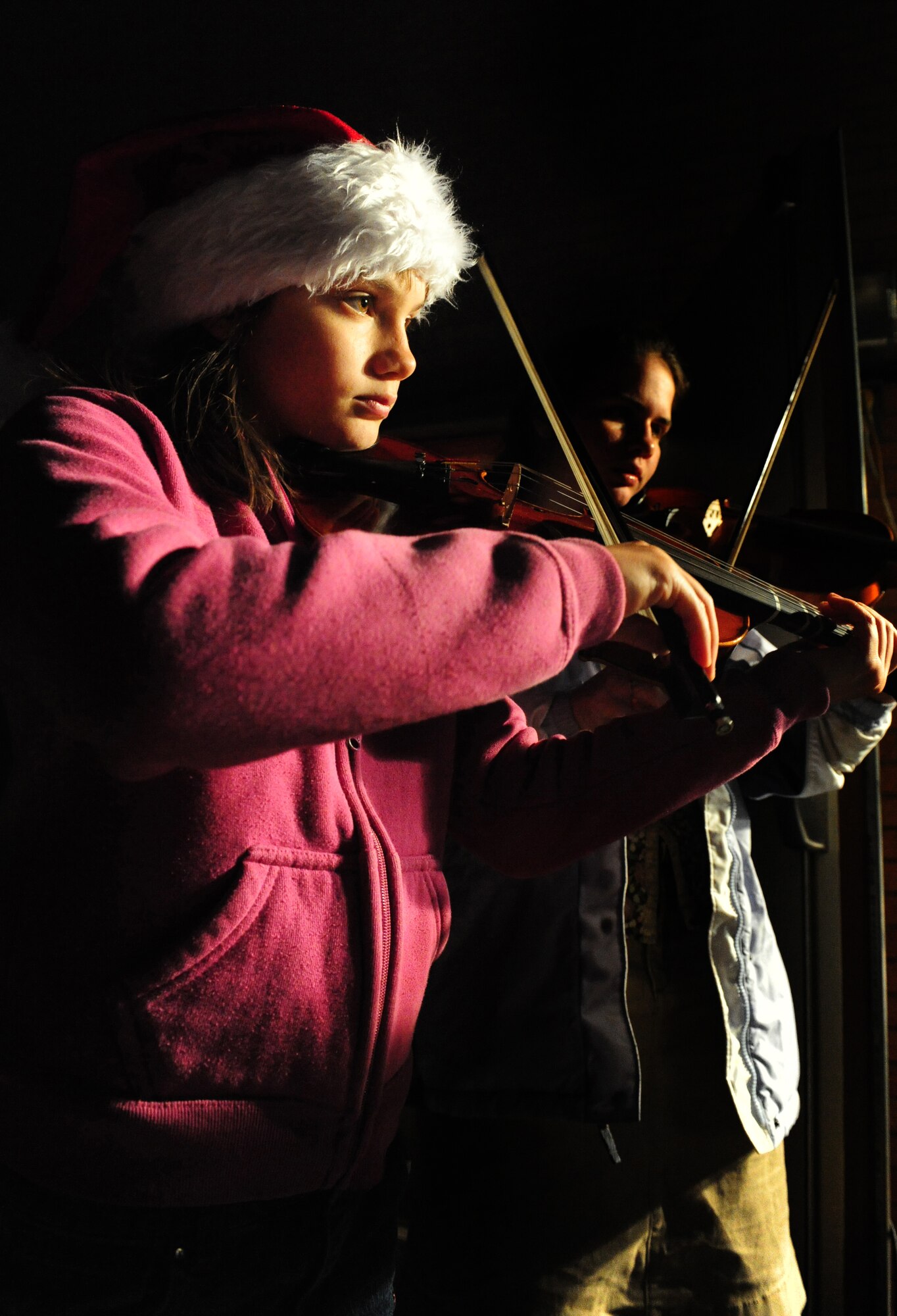 HOLLOMAN AIR FORCE BASE, N.M. -- Kayla Ross, 11, plays her violin during a tree and menorah lighting ceremony held at the base Chapel Dec. 7. The age-old tradition of lighting the tree and menorah symbolizes the start of the holiday season. (U.S. Air Force photo by Senior Airman Tiffany Trojca)