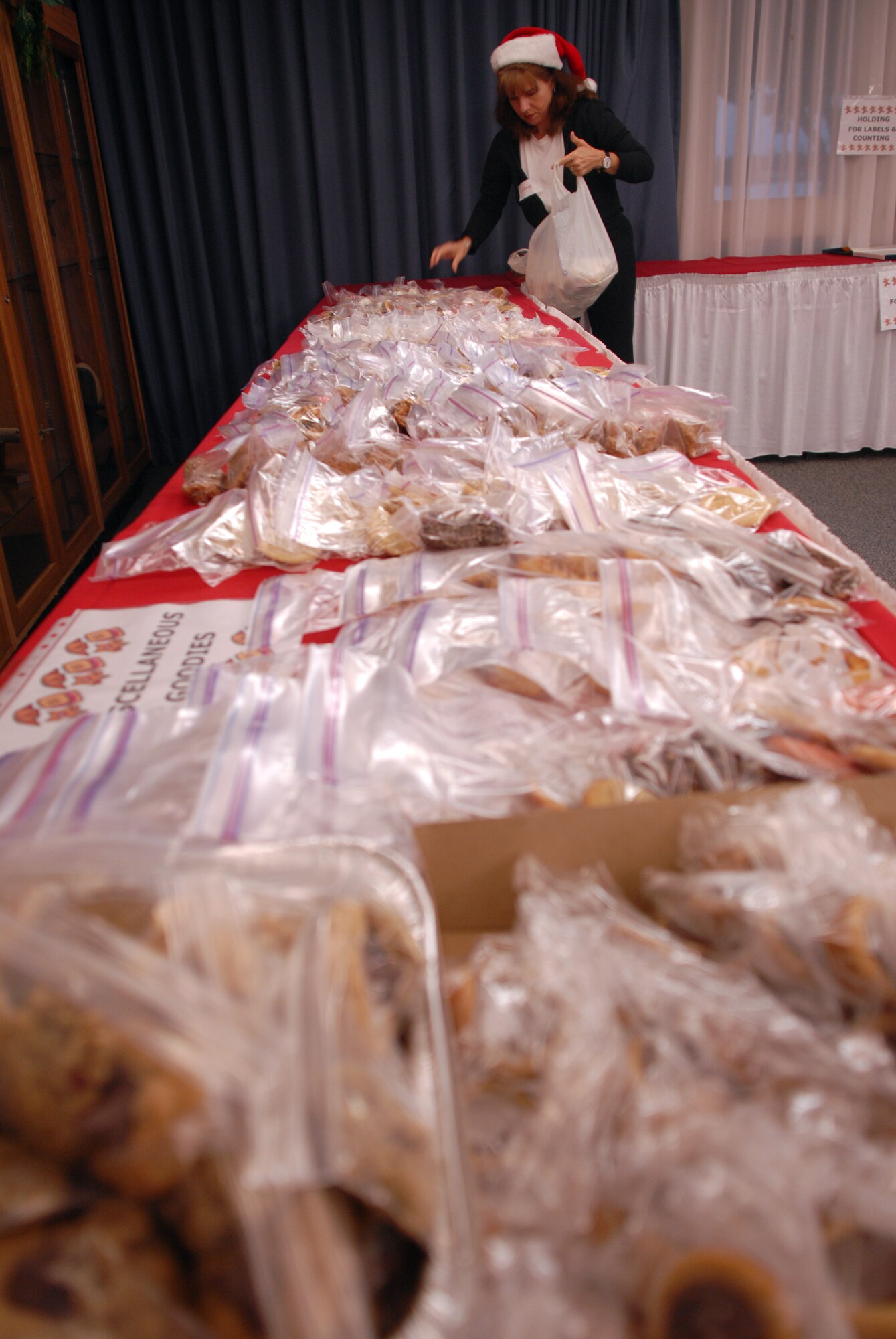 HICKAM AIR FORCE BASE, Hawaii - Joanie Howe seperates cookies during the annual Cookie Caper here, Dec. 10. Every year airmen living in the dorms recieve a bag of homemade cookies put together by volunteers. More than 398 airmen will recieve a bag of goodies this year. (U.S. Air Force photo/Senior Airman Gustavo Gonzalez)