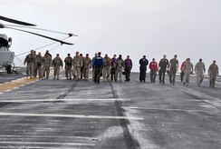 U.S. Army Soldiers join Navy Sailors and Marines in performing a Foreign Object Debris check on the flight deck of the U.S.S. Wasp multipurpose amphibious assault ship Dec. 9, 2009 prior to departure. Forty-six Soldiers from Joint Task Force-Bravo landed and stayed on the Wasp to practice taking off and landing on a ship. (U.S. Air Force photo/Tech. Sgt. Mike Hammond)