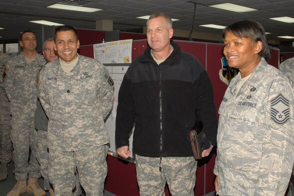 McGHEE TYSON AIR NATIONAL GUARD BASE, Tenn. -- Air Force Chief Master Sgt. Deborah F. Davidson, right, the commandant of the Paul H. Lankford Enlisted Professional Military Education Center, provides a tour of The I.G. Brown Air National Guard Training and Education Center here to The Lavern E. Weber National Guard Bureau Professional Education Center leadership, Army Lt. Col. Tomas DeLeon, left, and Army Col. John M. Frost, center, Dec. 8, 2009.  They visited the center to explore opportunities for collaboration between the Army and Air National Guard training centers. (U.S. Air Force photo by Master Sgt. Mavi Smith/Released)