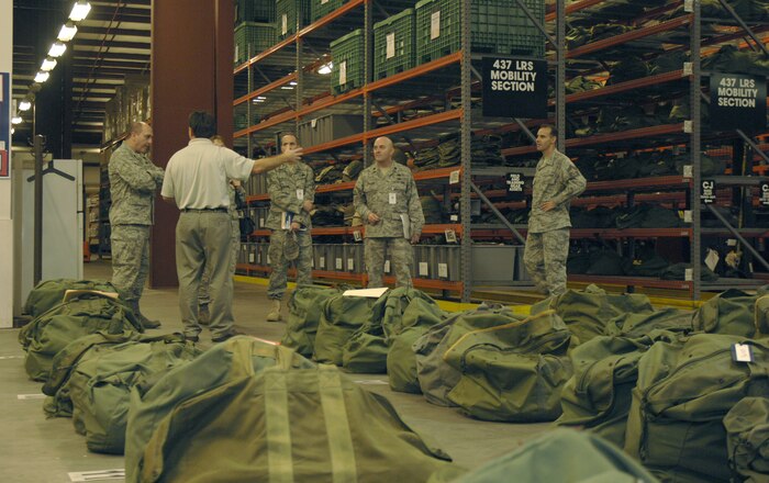 Lt. Col. Stevan Kaighen, second from right, Chief Master Sgt. Paul Baczewski, right, and Brian Jones, front, brief a group of Daedalion inspectors regarding the efficiency and effectiveness of the 437th Logistics Readiness Squadron here Dec. 9.  The 437 LRS is one of the top three logistics squadrons in Air Mobility Command and is a finalist for the Daedalian Maj. Gen. Warren R. Carter Logistics Effectiveness Award. Colonel Kaighen is the 437 LRS commander, Chief Baczewski is the 437 LRS superintendent and Mr. Jones is a deployment execution manager with the 437 LRS mobility section. (U.S. Air Force photo/Airman 1st Class Lauren Laidlaw)