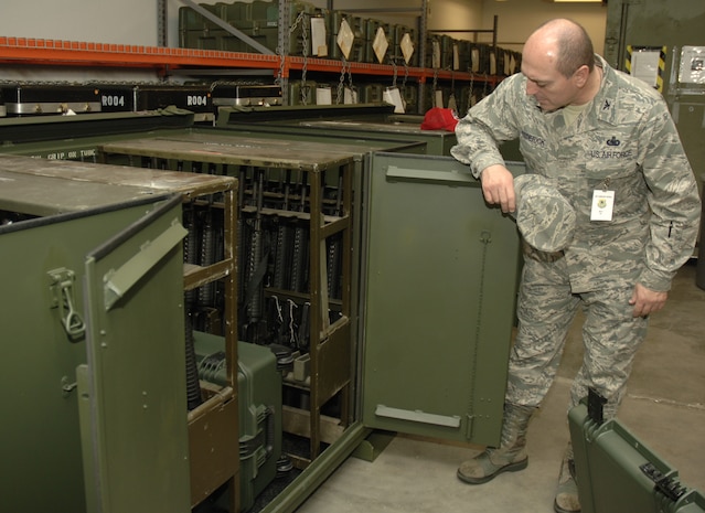 Col. Phillip Frederick inspects storage containers for weapons during the Daedalian Maj. Gen. Warren R. Carter Logistics Effectiveness Award inspection at the 437th Logistics Readiness Squadron mobility section here Dec. 9. The award encompass all logistics support to include logistics plans, fuels, transportation and supply. Colonel Frederick is the team chief for the Daedalian inspection team. (U.S. Air Force photo/Airman 1st Class Lauren Laidlaw)