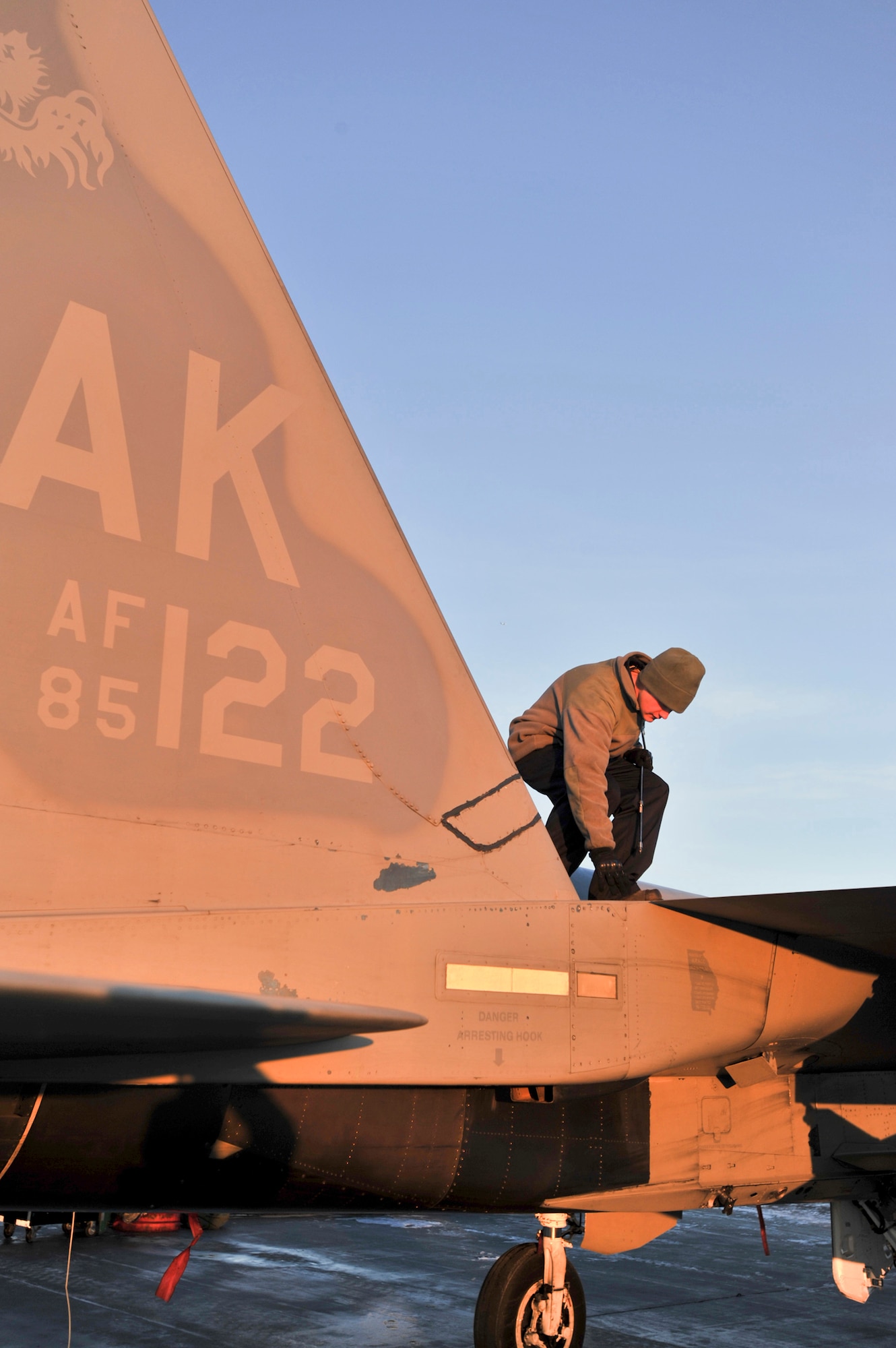 ELMENDORF AIR FORCE BASE, Alaska – Airman 1st Class Jasen Bohach, 19th Aircraft Maintenance Unit, checks the fastenings on top of an Elmendorf F-15 Eagle Dec. 7. The arctic maintainers work in temperatures as 40 below zero.  (U.S. Air Force photo/Airman 1st Class Christopher Gross)