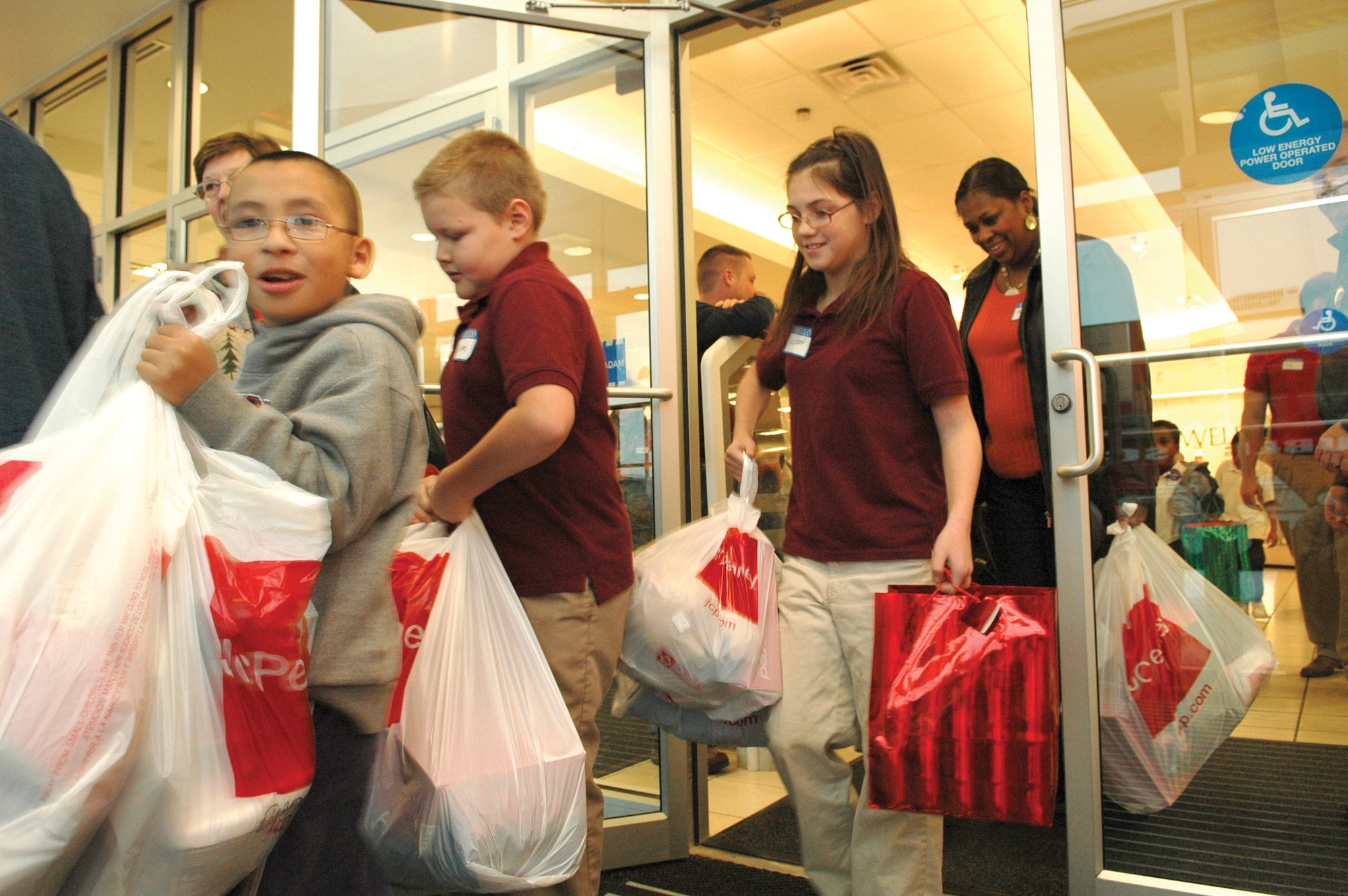 The B-52 Systems Program Office volunteers have been holding a Clothe-a-Kid drive for more than 30 years and on Dec. 8, they took 26 children shopping at the same department store. Full bags and smiles are on display as the children leave from their shopping trip.(Air Force photo by 1st Lt. Sam Lee)
