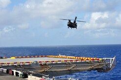 A U.S. Army CH-47 Chinook approaches the flight deck of the U.S.S. Wasp mulitipurpose amphibious assault ship during deck landing qualification training Dec. 8, 2009. Forty-six U.S. Army aircrew members conducted the training with the Chinook and  Blackhawk helicopters, staying aboard the Wasp while underway in the Caribbean Sea. (U.S. Air Force photo/Tech. Sgt. Mike Hammond)