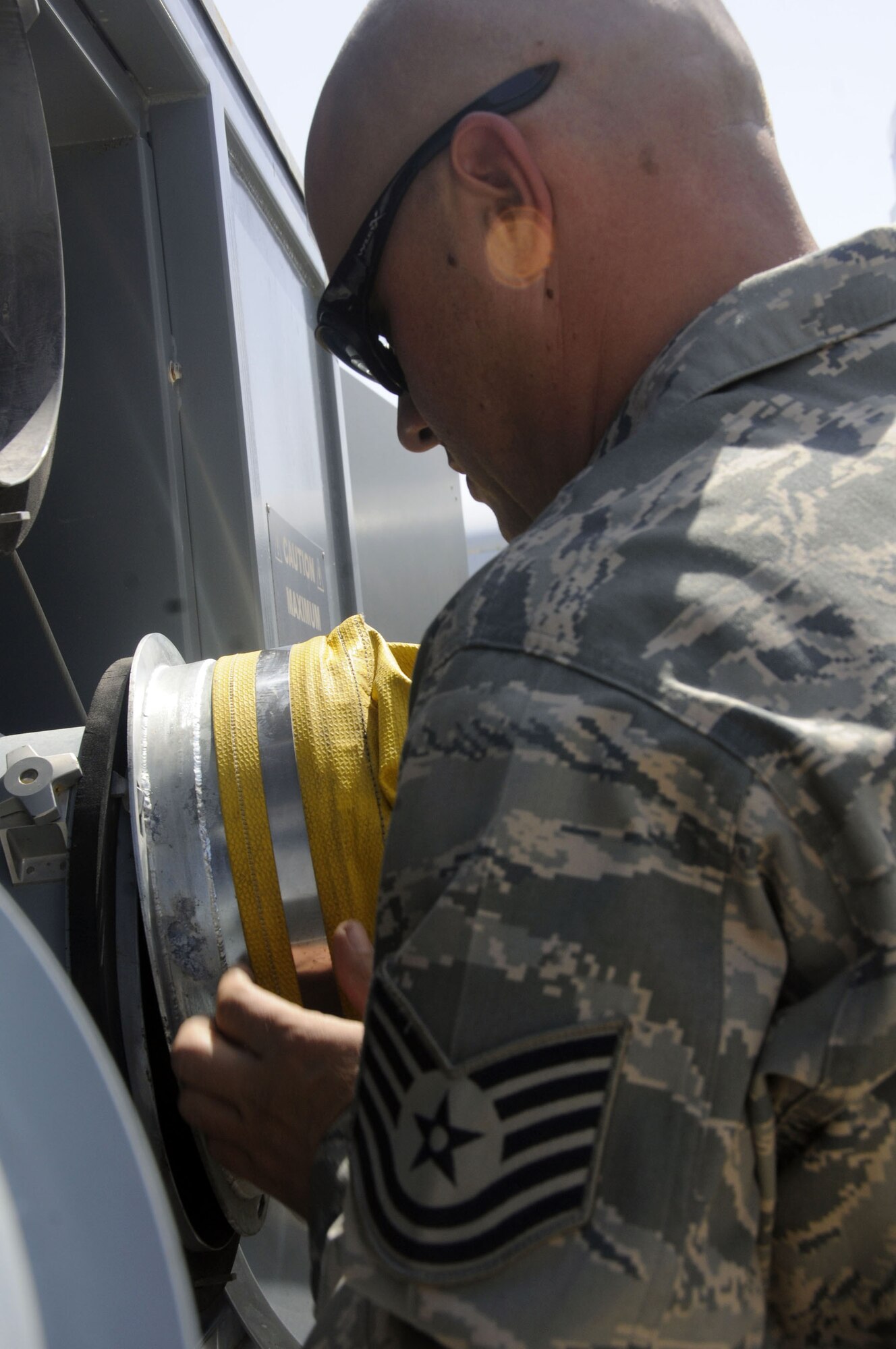 Tech. Sgt. Jason Blurton attaches a duct to a 110-ton flightline diesel air conditioner that provides conditioned air for ground testing of aircraft at Robins Air Force Base, Ga. Sergeant Blurton is assigned to the 642nd Combat Sustainment Group. (U.S. Air Force photo/Staff Sgt. Darnell T. Cannady)