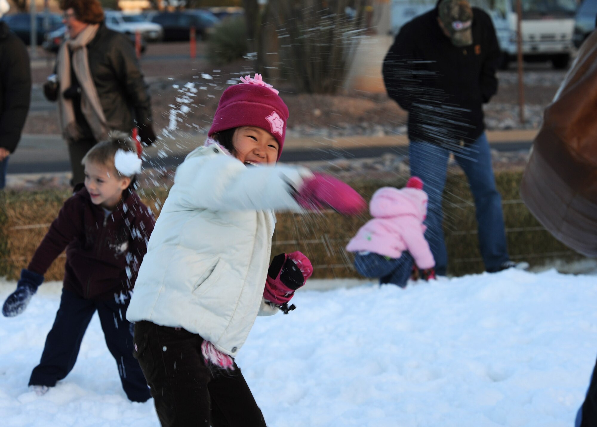Five-year-old Lia Erbe, daughter of Lt. Col. Sue Ellen Schuerman, 51st Fighter Wing assistant staff judge advocate, throws snow during the 5th annual Starry Snowy Night event here Dec. 8. Hosted by the 355th Force Support Squadron, this event welcomed hundreds of military personnel and their families and featured booths and fun activities for everyone to enjoy in celebration of the holiday season. (U.S. Air Force photo/Airman Jerilyn Quintanilla)
