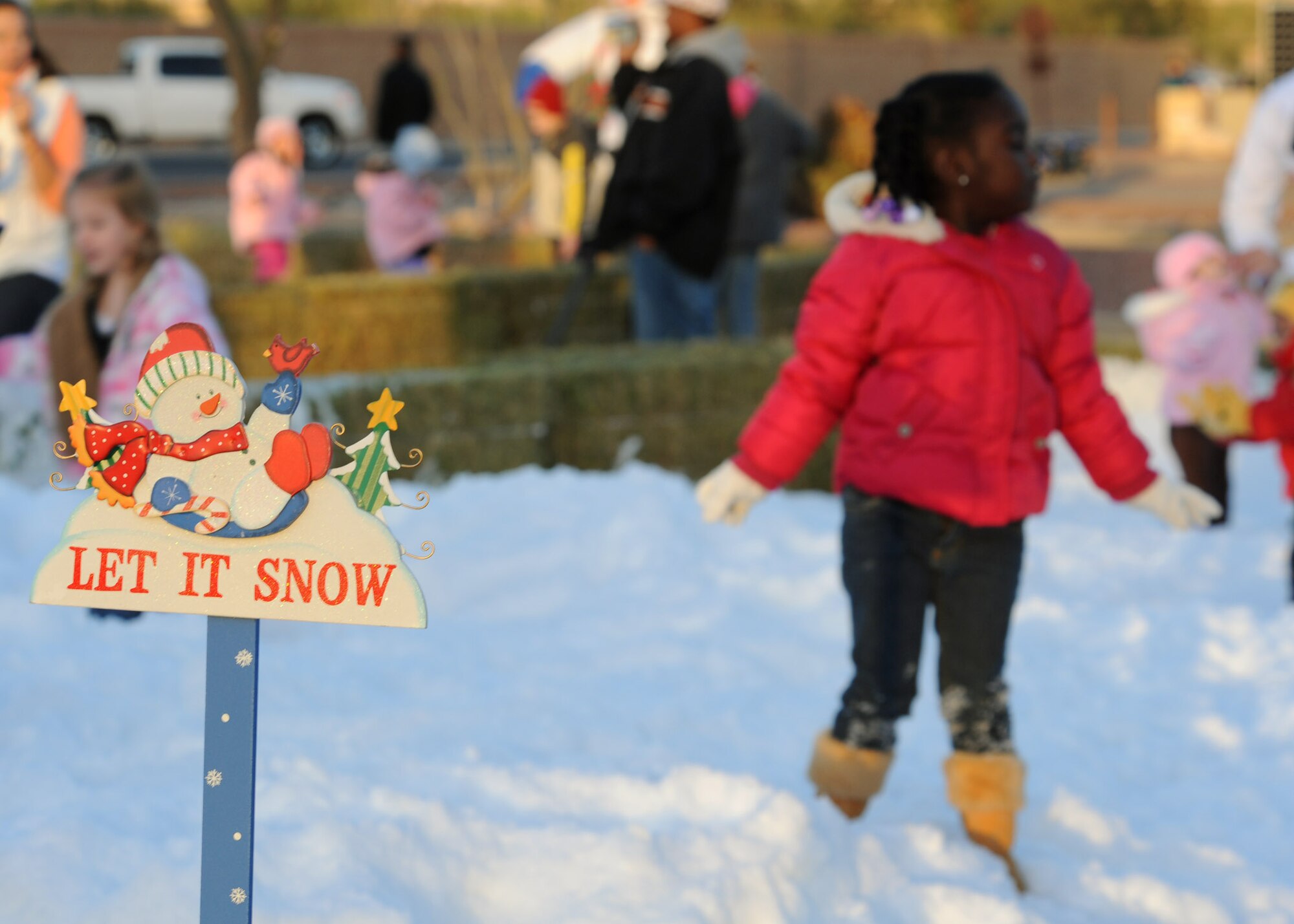 Four-year-old Mariah Wallace, daughter of Staff Sgt. Sam Wallace, 357th Aircraft Maintenance Unit, plays in the snow during the 5th annual Starry Snowy Night event here Dec. 8. Hosted by Brig. Gen. Paul Johnson, 355th Fighter Wing commander, and the 355th Force Support Squadron, this event drew in volunteers from various squadrons on base as well as from the Davis-Monthan youth center. (U.S. Air Force photo/Airman Jerilyn Quintanilla)
